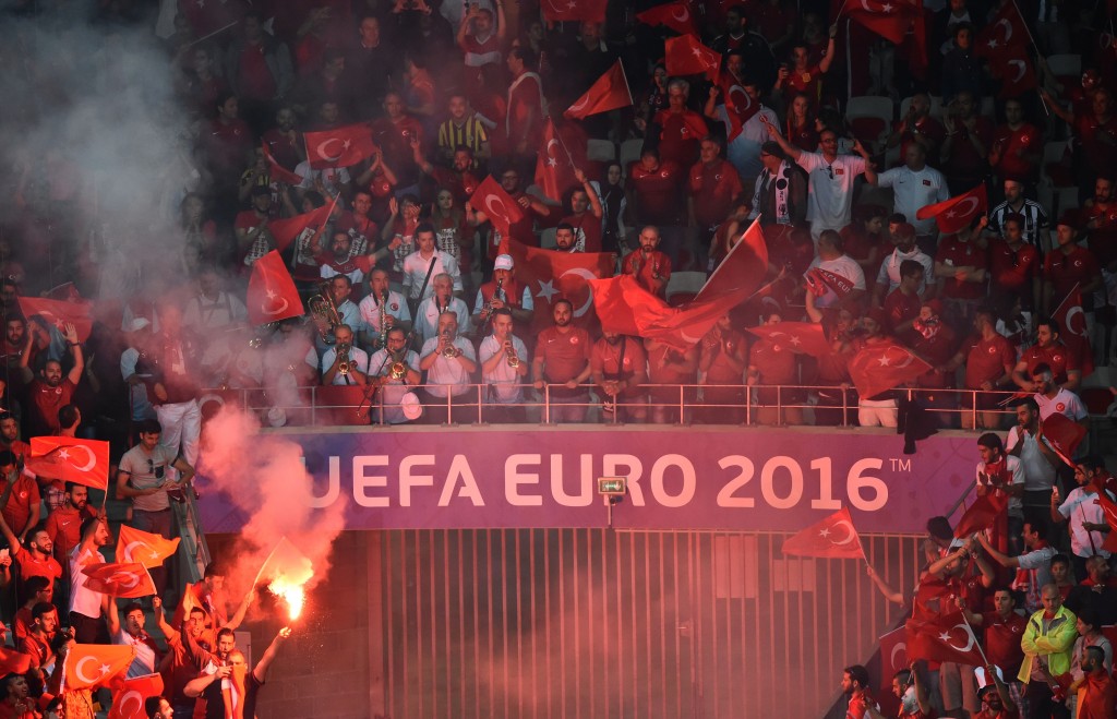 Turkey supporters light flares during the Euro 2016 group D football match between Spain and Turkey at the Allianz Riviera stadium in Nice on June 17, 2016. / AFP / BERTRAND LANGLOIS (Photo credit should read BERTRAND LANGLOIS/AFP/Getty Images)
