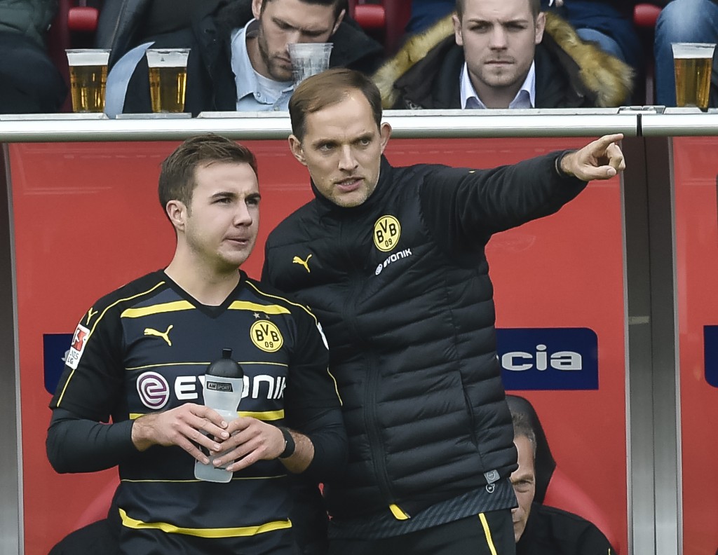 Dortmund's head coach Thomas Tuchel gives Dortmund's midfielder Mario Goetze instructions during the German first division Bundesliga football match between FC Ingolstadt 04 and Borussia Dortmund in Ingolstadt, southern Germany, on October 22, 2016. / AFP / GUENTER SCHIFFMANN / RESTRICTIONS: DURING MATCH TIME: DFL RULES TO LIMIT THE ONLINE USAGE TO 15 PICTURES PER MATCH AND FORBID IMAGE SEQUENCES TO SIMULATE VIDEO. == RESTRICTED TO EDITORIAL USE == FOR FURTHER QUERIES PLEASE CONTACT DFL DIRECTLY AT + 49 69 650050 (Photo credit should read GUENTER SCHIFFMANN/AFP/Getty Images)