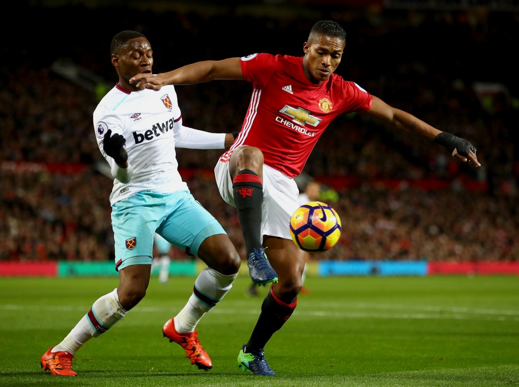 MANCHESTER, ENGLAND - NOVEMBER 27: Diafra Sakho of West Ham United (L) puts pressure on Antonio Valencia of Manchester United (R) who attempts to control the ball during the Premier League match between Manchester United and West Ham United at Old Trafford on November 27, 2016 in Manchester, England. (Photo by Clive Brunskill/Getty Images)