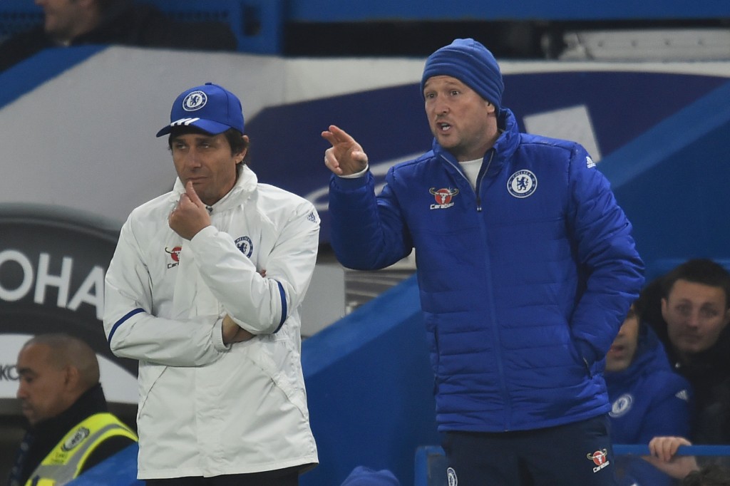 Chelsea's assistant coach Steve Holland (R) gestures next to Chelsea's Italian head coach Antonio Conte (L) on the touchline during the English FA Cup third round football match between Chelsea and Peterborough at Stamford Bridge in London on January 8, 2017. (Photo by Glyn Kirk/AFP/Getty Images)