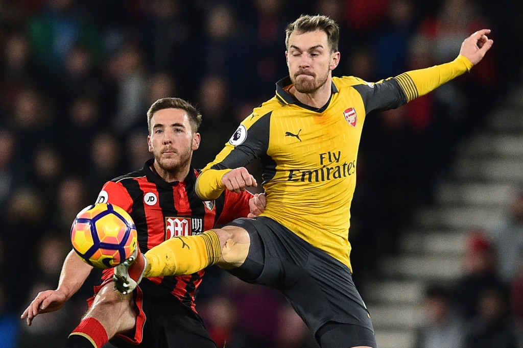 Arsenal's Welsh midfielder Aaron Ramsey (R) vies with Bournemouth's English midfielder Dan Gosling during the English Premier League football match between Bournemouth and Arsenal at the Vitality Stadium in Bournemouth, southern England on January 3, 2017. / AFP / Glyn KIRK / RESTRICTED TO EDITORIAL USE. No use with unauthorized audio, video, data, fixture lists, club/league logos or 'live' services. Online in-match use limited to 75 images, no video emulation. No use in betting, games or single club/league/player publications. / (Photo credit should read GLYN KIRK/AFP/Getty Images)