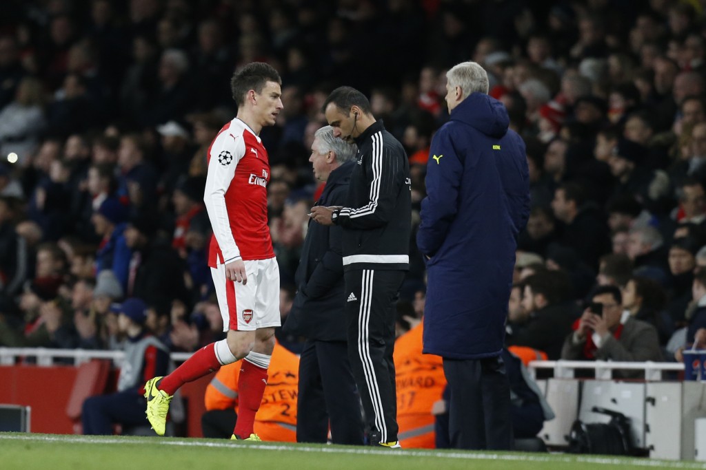 Arsenal's French defender Laurent Koscielny (L) leaves the pitch after being given a red card during the UEFA Champions League last 16 second leg football match between Arsenal and Bayern Munich at The Emirates Stadium in London on March 7, 2017. / AFP PHOTO / IKIMAGES / Ian KINGTON (Photo credit should read IAN KINGTON/AFP/Getty Images)