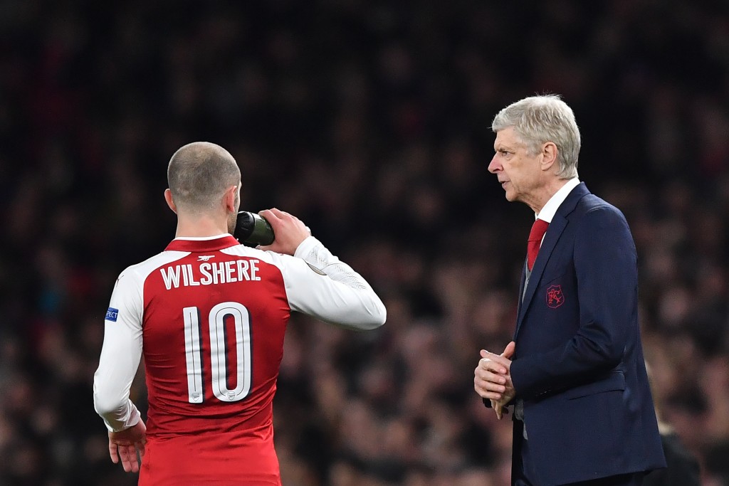 Arsenal's French manager Arsene Wenger (R) talks to Arsenal's English midfielder Jack Wilshere during the UEFA Europa League round of 16 second-leg football match between Arsenal and AC Milan at the Emirates Stadium in London on March 15, 2018. / AFP PHOTO / Ben STANSALL (Photo credit should read BEN STANSALL/AFP/Getty Images)