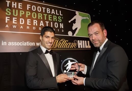 Former Liverpool striker Luis Suarez receiving the Football Supporters' Federation Player of the Year award