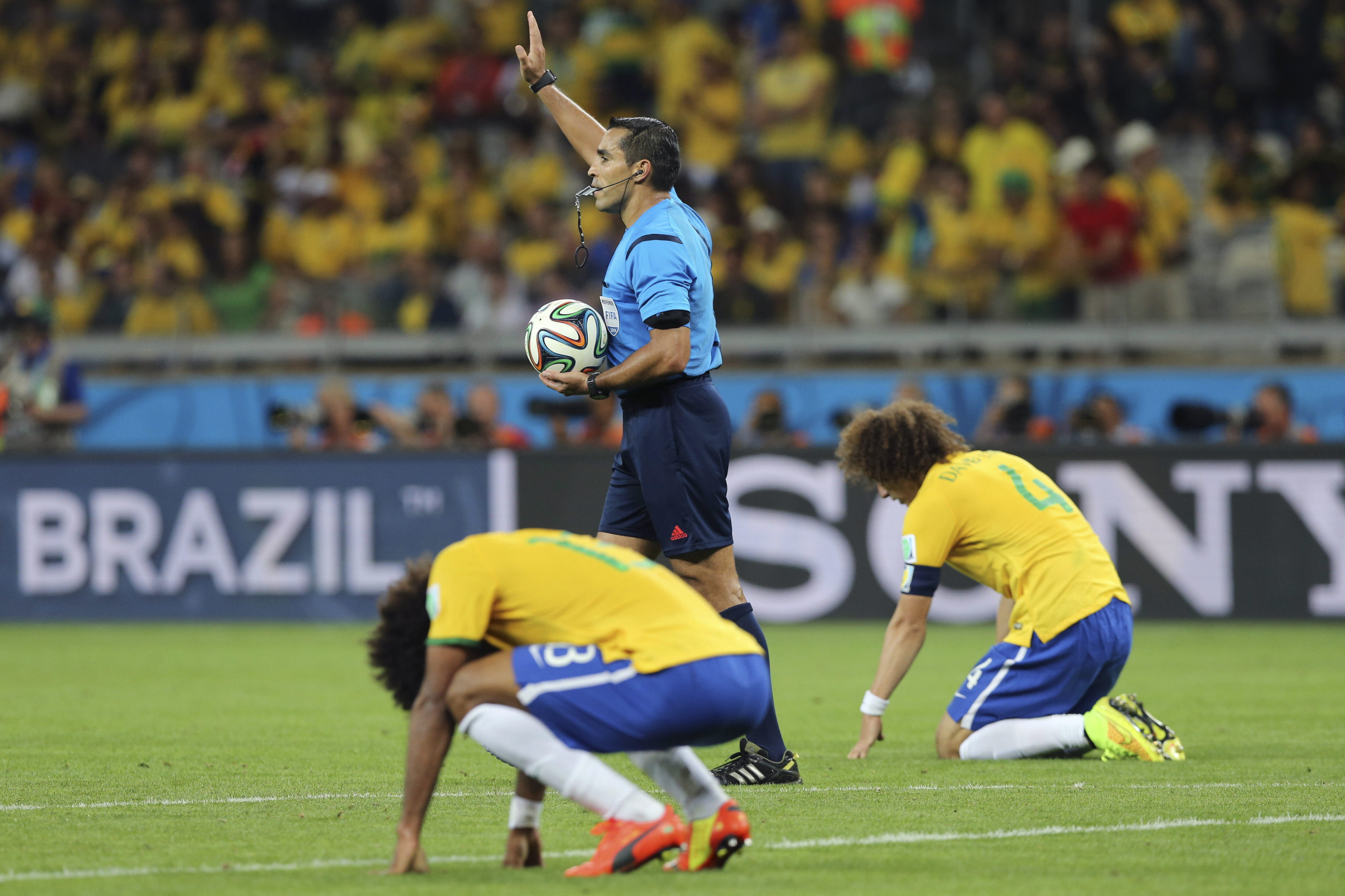 epaselect epa04306497 Referee Marco Rodriguez (C) blows the final whistle in front of Brazil's David Luiz (R) and Dante (L) in the FIFA World Cup 2014 semi final match between Brazil and Germany at the Estadio Mineirao in Belo Horizonte, Brazil, 08 July 2014. Germany won 7-1. 

(RESTRICTIONS APPLY: Editorial Use Only, not used in association with any commercial entity - Images must not be used in any form of alert service or push service of any kind including via mobile alert services, downloads to mobile devices or MMS messaging - Images must appear as still images and must not emulate match action video footage - No alteration is made to, and no text or image is superimposed over, any published image which: (a) intentionally obscures or removes a sponsor identification image; or (b) adds or overlays the commercial identification of any third party which is not officially associated with the FIFA World Cup)  EPA/Ballesteros   EDITORIAL USE ONLY