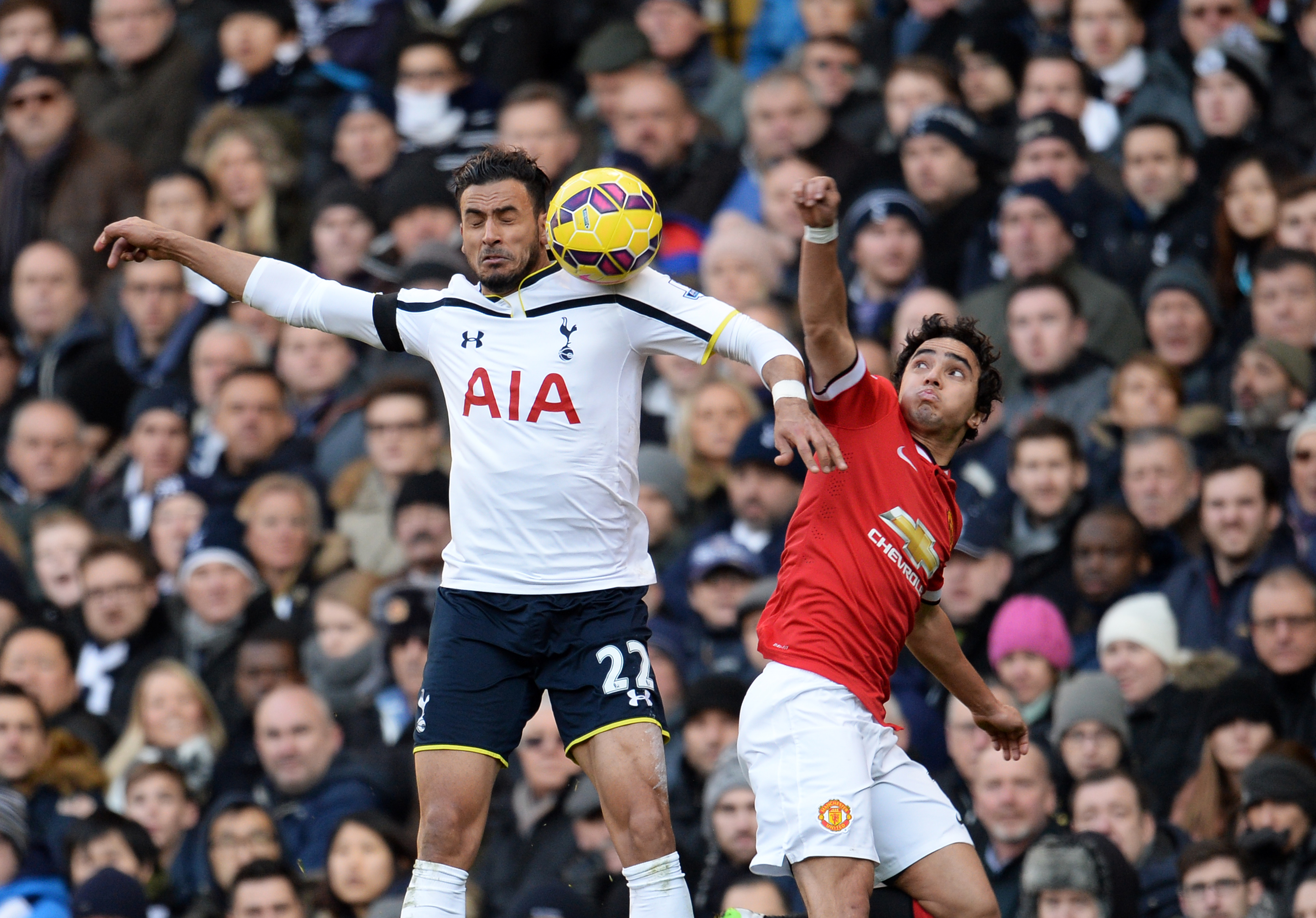 epa04541439 Manchester United Rafael Da Silva (R) vies for the ball with Tottenham's Nacer Chadli (L) during an English Premier League soccer match at White Hart Lane in London, Britain, 28 December 2014.  EPA/ANDY RAIN DataCo terms and conditions apply. http://www.epa.eu/downloads/DataCo-TCs.pdf