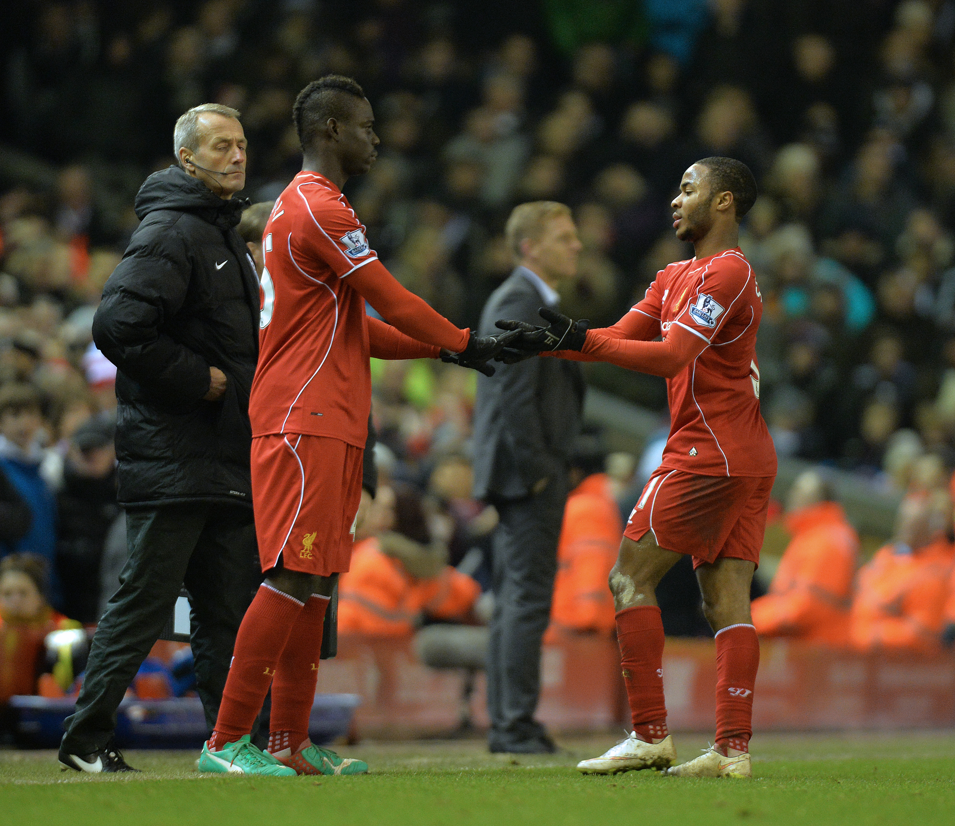 epa04542563 Liverpool's Raheem Sterling (R) is replaced by substitute Mario Balotelli (L) during the English Premier League soccer match between Liverpool and Swansea at the Anfield in Liverpool, Britain, 29 December 2014.  EPA/PETER POWELL DataCo terms and conditions apply 
http://www.epa.eu/files/Terms%20and%20Conditions/DataCo_Terms_and_Conditions.pdf