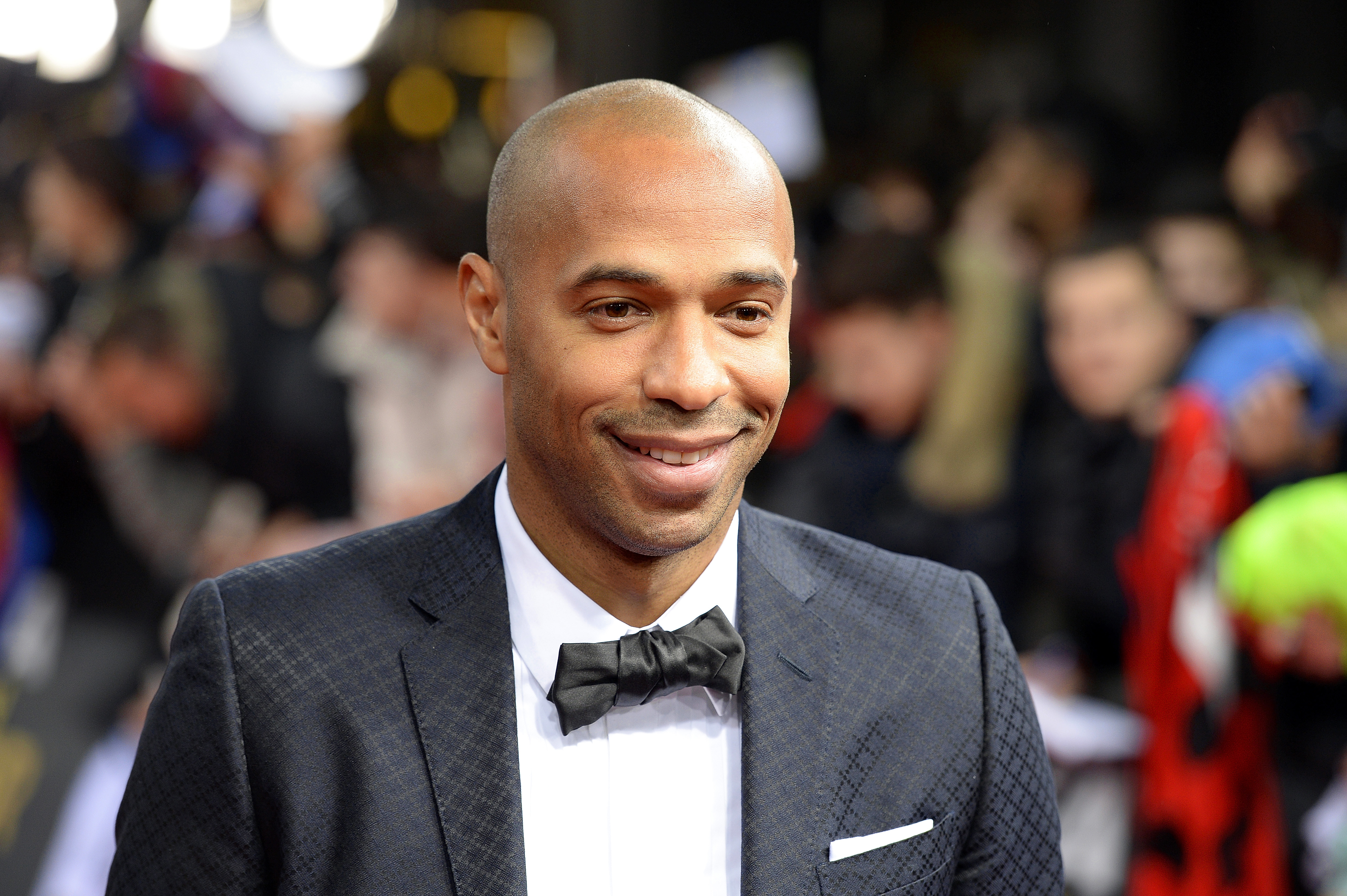 epa04557439 Former French soccer player Thierry Henry arrives on the red carpet prior to the FIFA Ballon d'Or 2014 gala held at the Kongresshaus in Zurich, Switzerland, 12 January 2015.  EPA/WALTER BIERI