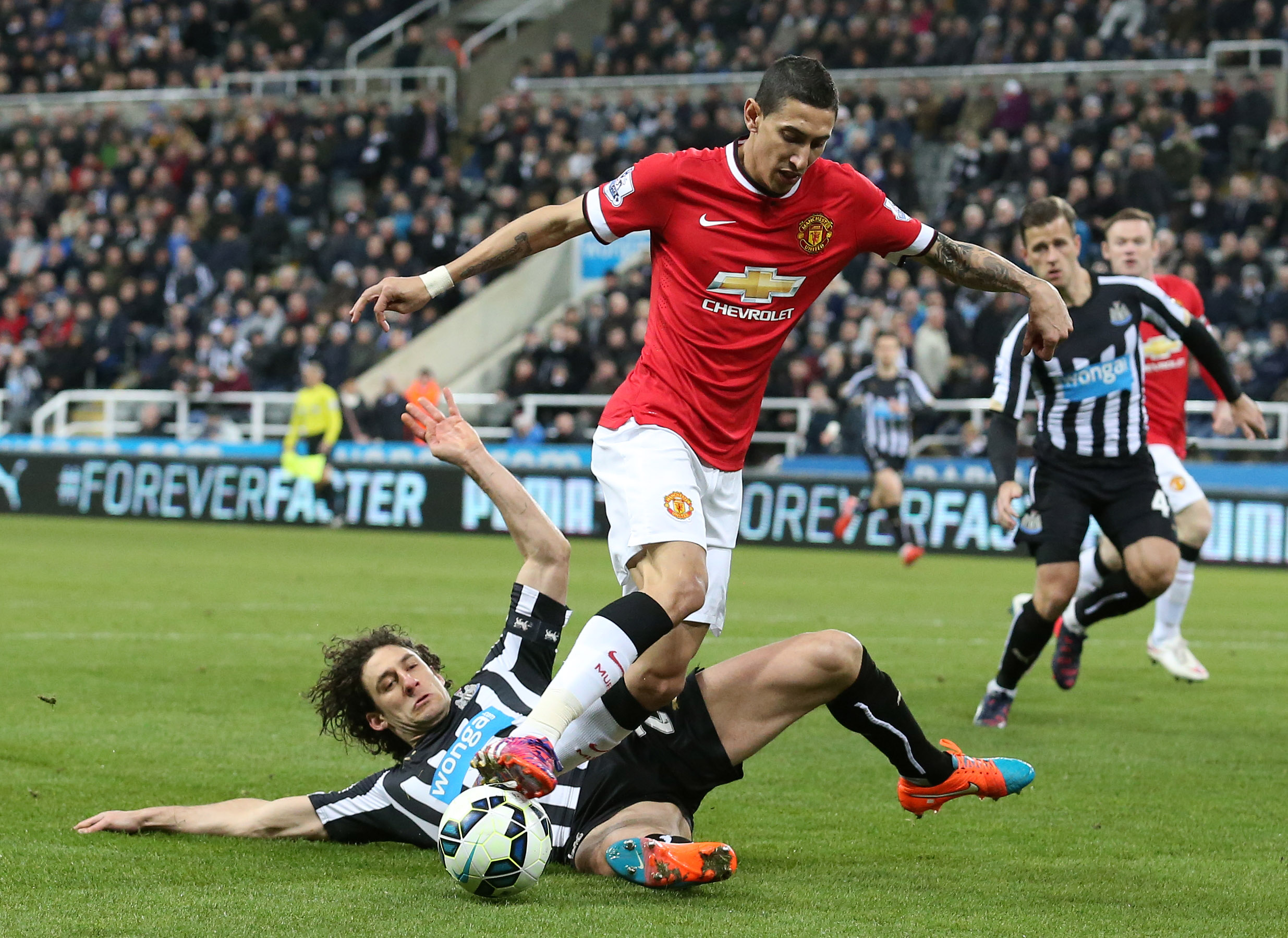 epa04647939 Newcastle United's Fabricio Coloccini (bottom) challenges Manchester United's Angel Di Maria during the English Premier League soccer match between Newcastle United and Manchester United at St James' Park in Newcastle, Britain, 04 March 2015. Manchester United won the match 1-0.  EPA/LINDSEY PARNABY DataCo terms and conditions apply http//www.epa.eu/downloads/DataCo-TCs.pdf