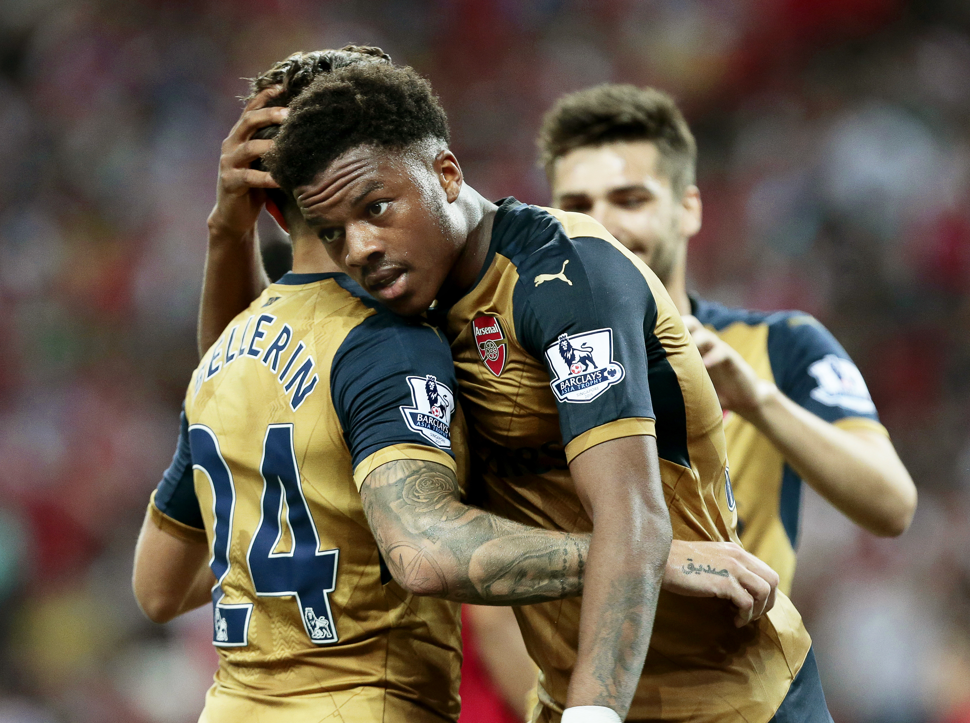 epa04847847 Arsenal forward Chuba Akpom (C) celebrates with his teammates Hector Bellerin (L) and Jon Toral (R) after scoring a hattrick during the Barclays Asia Trophy soccer match between Arsenal FC and a Singapore Selection at the National Stadium in Singapore, 15 July 2015. The Barclays Asia Trophy takes place on 15 and 18 July 2015 involving English Premier League teams Arsenal, Everton, and Stoke City and a Singapore Selection team.  EPA/WALLACE WOON