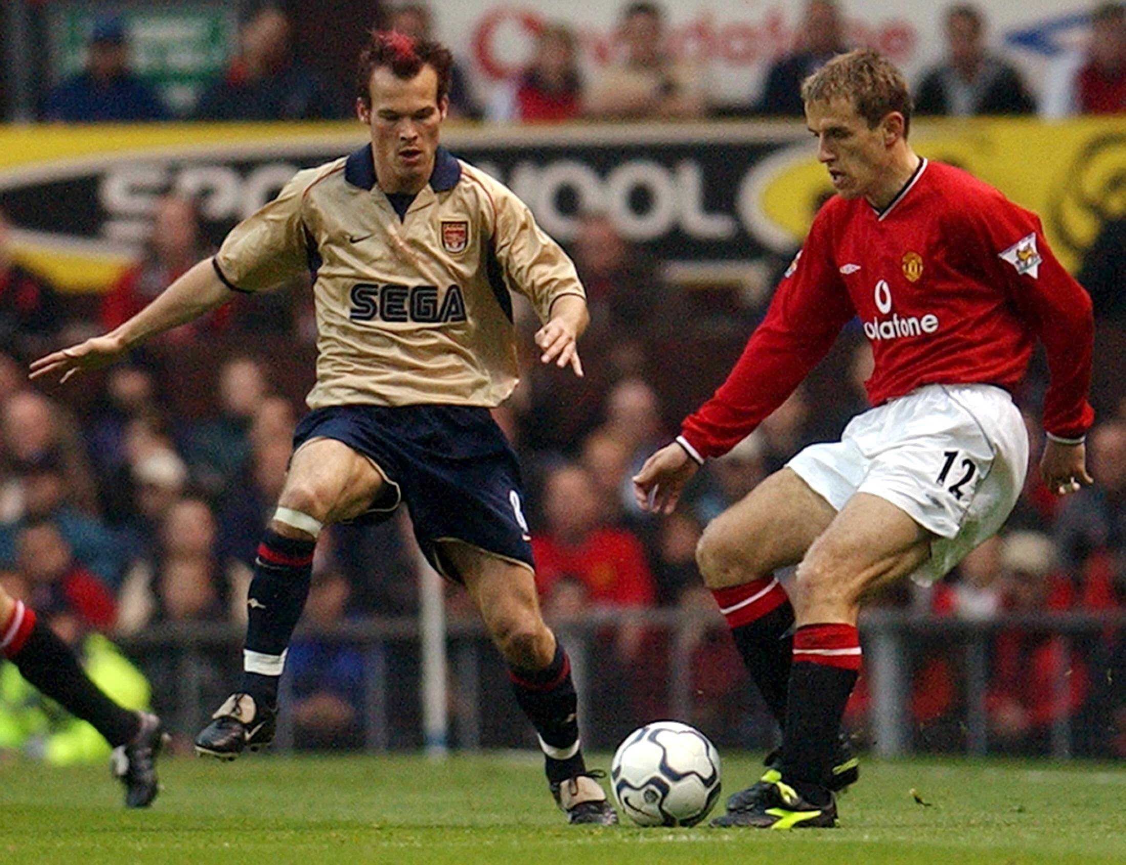 ODD001 - 20020508 - MANCHESTER, UNITED KINGDOM: Arsenal's Frederik Ljungberg (L) challenges Gary Neville of Manchester United during a premier league match at Old Trafford, 08 May 2002. Arsenal will clinch the premiership and secure their double with a win or draw. EPA PHOTO  EPA  PAUL BARKER