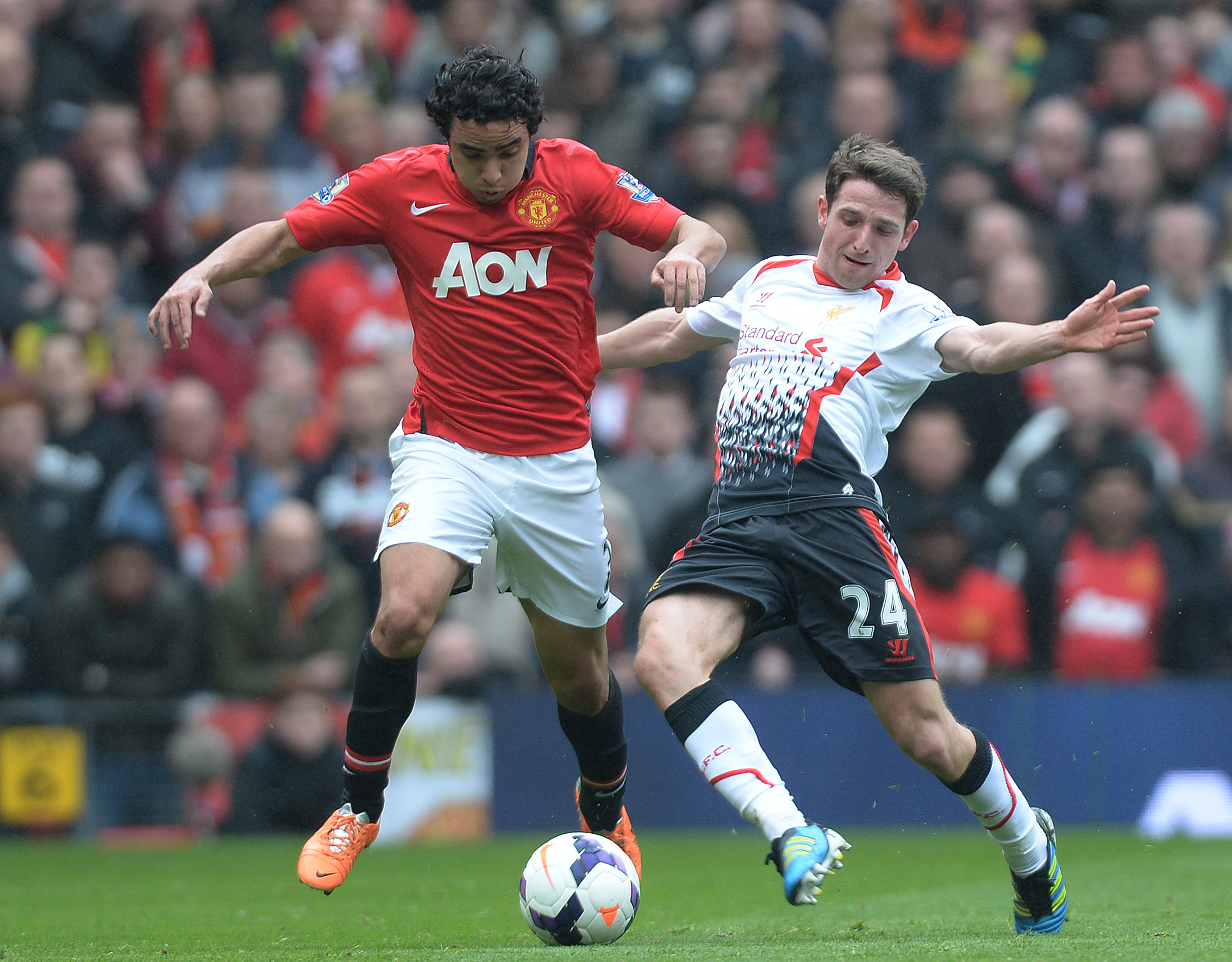 epa04128650 Liverpool's Joe Allen (R) in action with Manchester United's Rafael Da Silva (L) during the English Premier League soccer match Manchester United FC vs Liverpool FC at Old Trafford, Manchester, Britain, 16 March 2014.  EPA/PETER POWELL DataCo terms and conditions apply https://www.epa.eu/downloads/DataCo-TCs.pdf