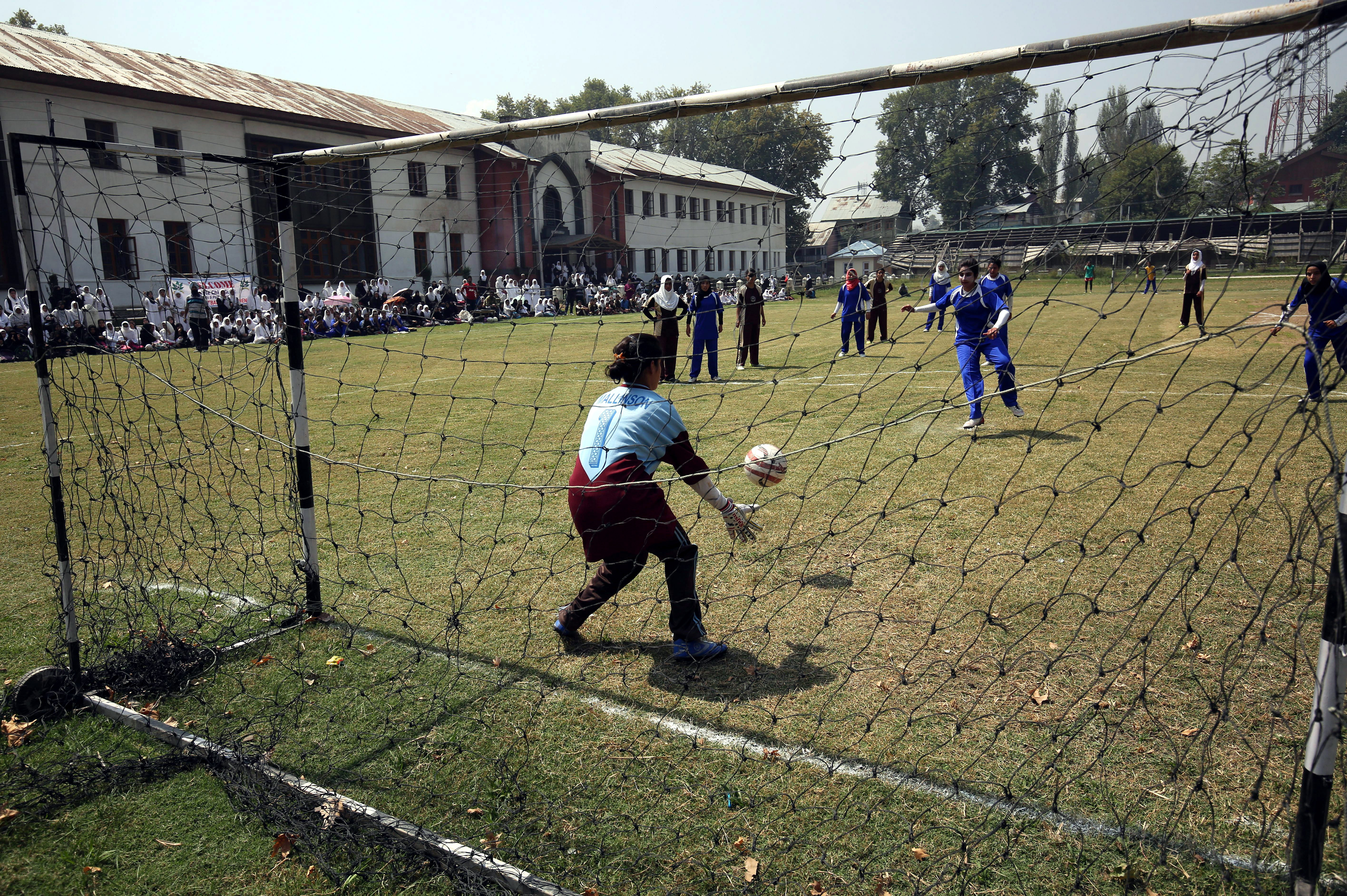 epa04923873 Kashmiri female students play a soccer match at the Women's College in Srinagar, the summer capital of Indian Kashmir, 10 September 2015. Kashmiri girls have started participating in various sports activities and of late in sports like soccer and cricket, which were earlier considered to be a male-dominated sports.  EPA/FAROOQ KHAN