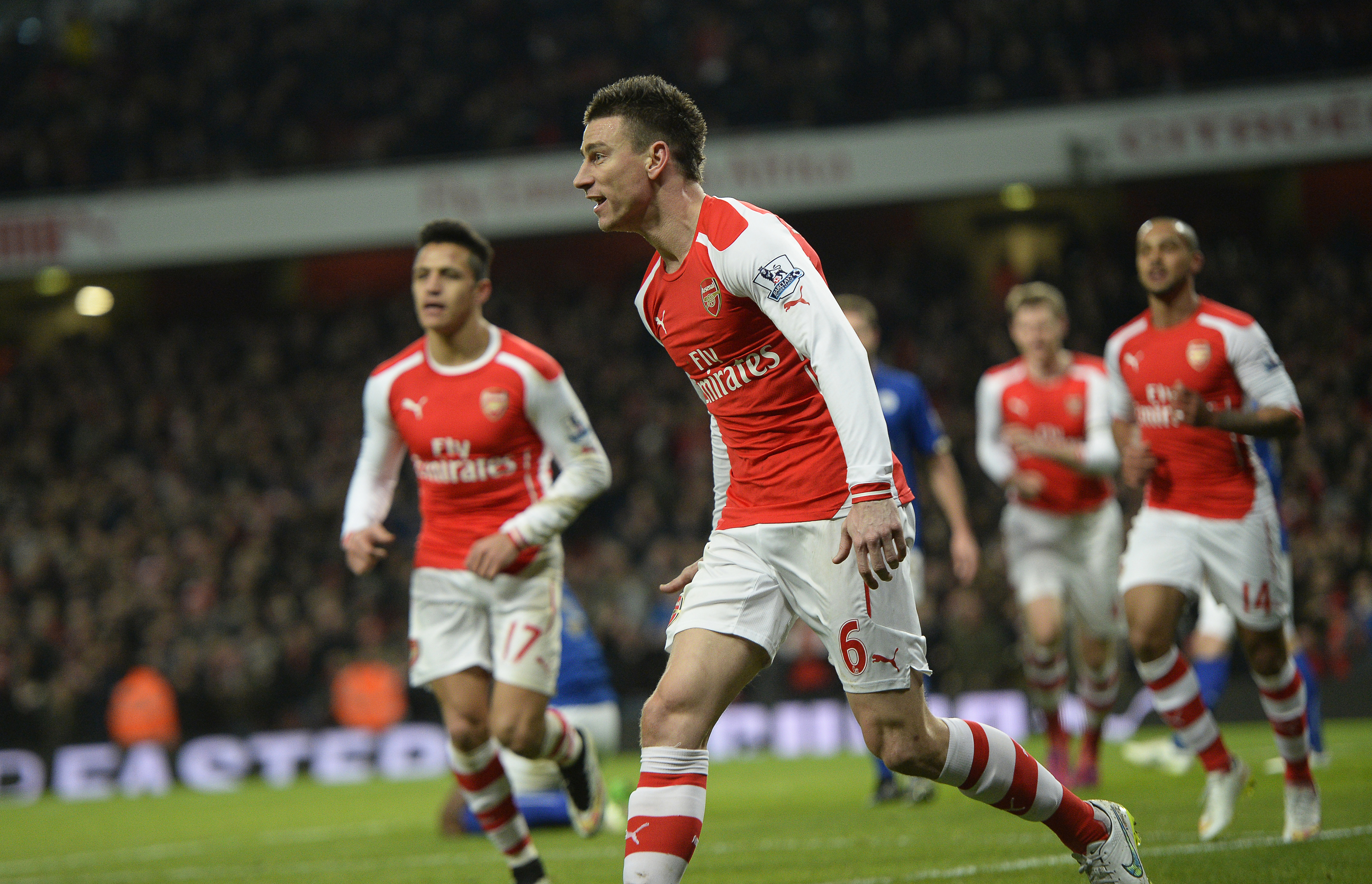 epa04613477 Arsenal's Laurent Koscielny (C) celebrates after scoring the 1-0 lead during the English Premier League soccer match between Arsenal FC and Leicester City in London, Britain, 10 February 2015.  EPA/FACUNDO ARRIZABALAGA DataCo terms and conditions apply. http://www.epa.eu/files/Terms%20and%20Conditions/DataCo_Terms_and_Conditions.pdf