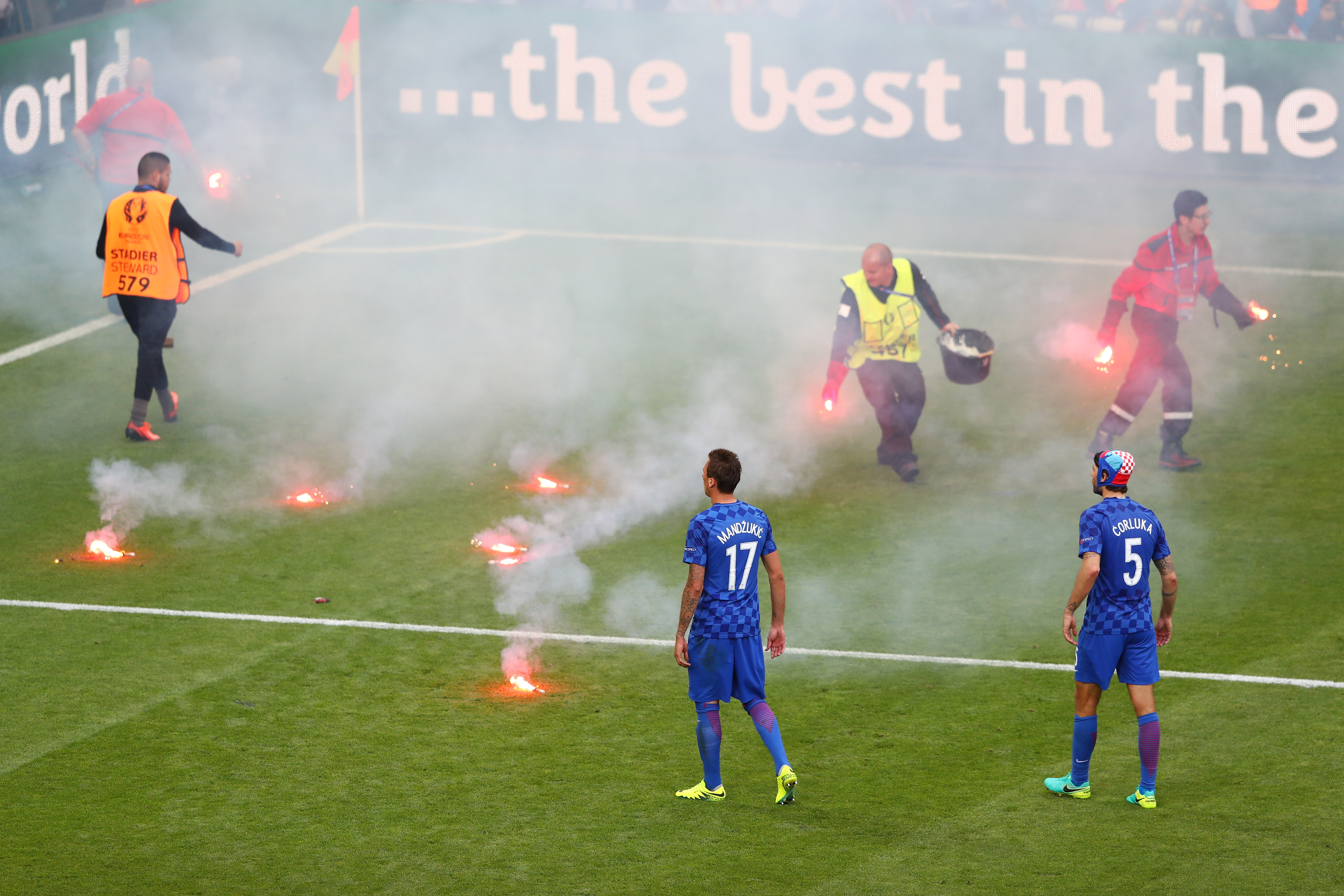 SAINT-ETIENNE, FRANCE - JUNE 17: Mario Mandzukic of Croatia and Vedran Corluka of Croatia look on as fire marshal's take flares from the pitch during the UEFA EURO 2016 Group D match between Czech Republic and Croatia at Stade Geoffroy-Guichard on June 17, 2016 in Saint-Etienne, France.  (Photo by Michael Steele/Getty Images)