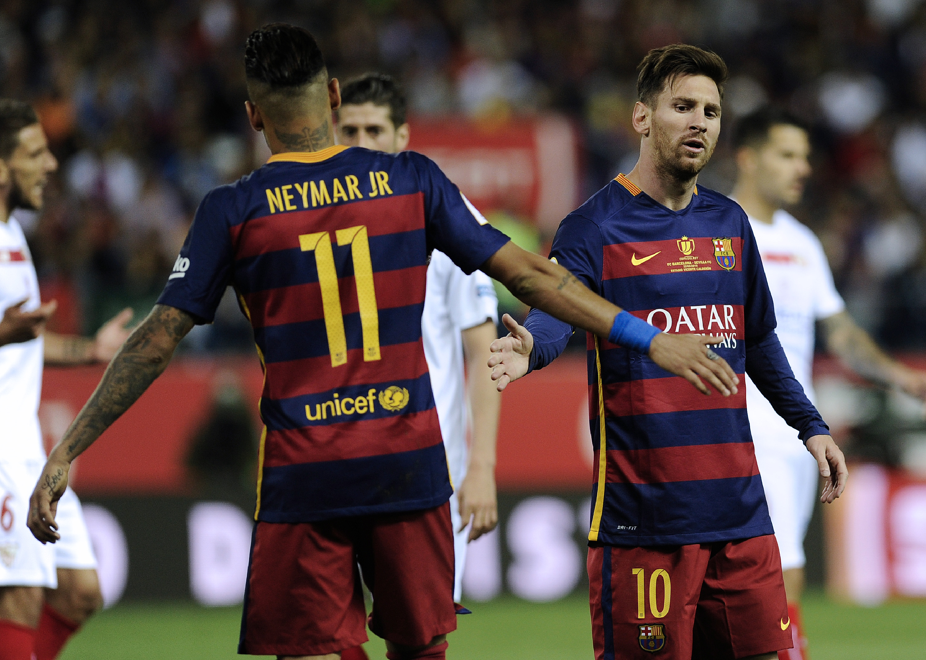 Barcelona's Brazilian forward Neymar (L) cheers Barcelona's Argentinian forward Lionel Messi during the Spanish "Copa del Rey" (King's Cup) final match FC Barcelona vs Sevilla FC at the Vicente Calderon stadium in Madrid on May 22, 2016. / AFP / CRISTINA QUICLER        (Photo credit should read CRISTINA QUICLER/AFP/Getty Images)