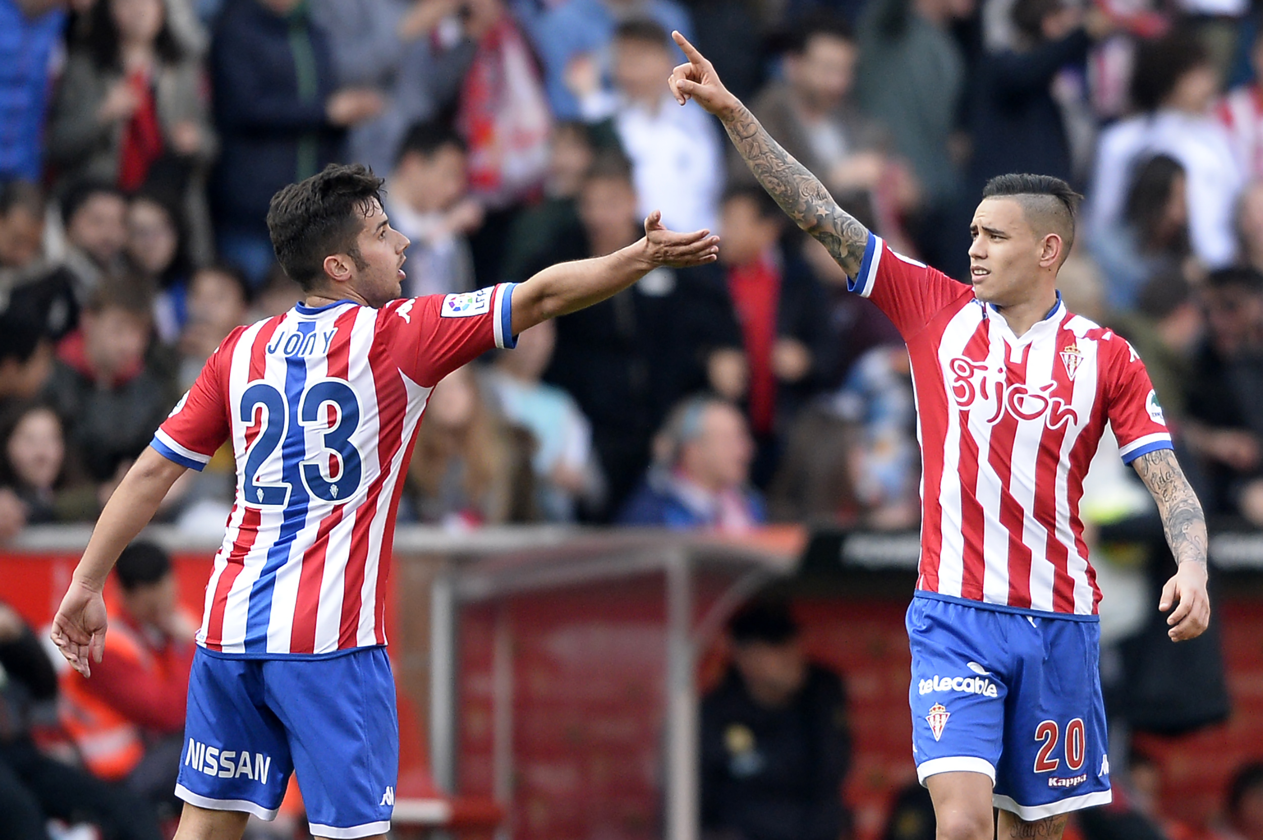 Sporting Gijon's Paraguayan forward Sanabria (R) celebrates after scoring a goal next to teammate Sporting Gijon's midfielder Jony during the Spanish league football match Real Sporting de Gijon vs Club Atletico de Madrid at El Molinon stadium in Gijon on March 19, 2016. Sporting won the match 2-1.  / AFP / MIGUEL RIOPA        (Photo credit should read MIGUEL RIOPA/AFP/Getty Images)