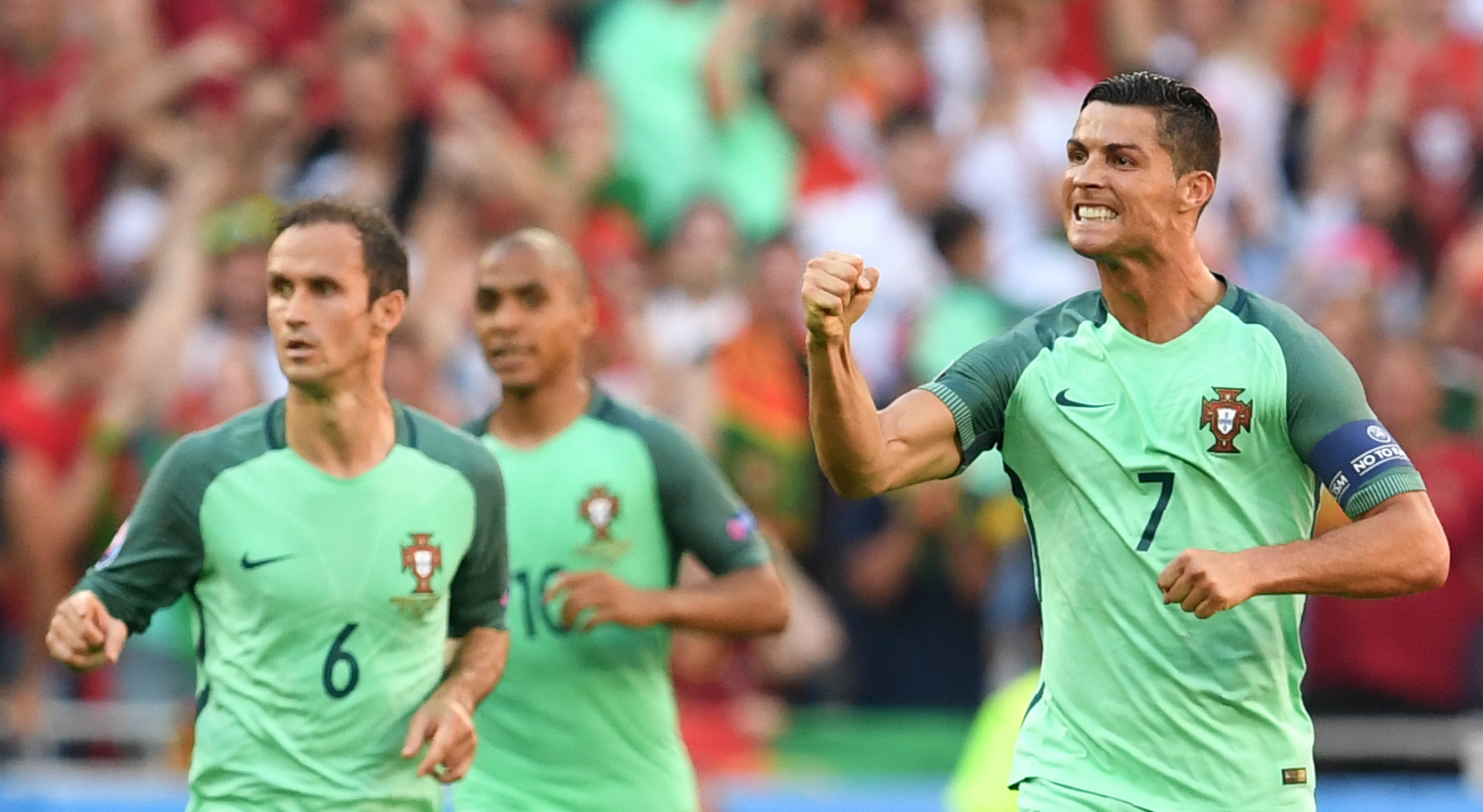 Portugal's forward Cristiano Ronaldo (R) celebrates after scoring a goal during the Euro 2016 group F football match between Hungary and Portugal at the Parc Olympique Lyonnais stadium in Decines-Charpieu, near Lyon, on June 22, 2016. / AFP / FRANCISCO LEONG        (Photo credit should read FRANCISCO LEONG/AFP/Getty Images)