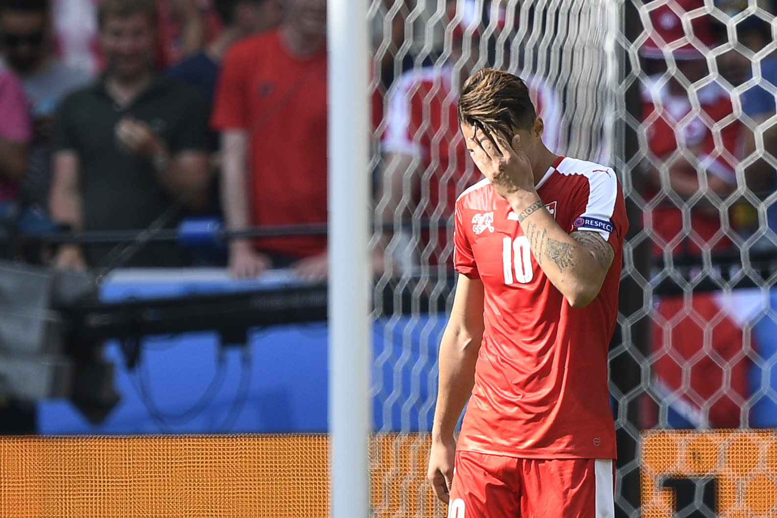 Switzerland's midfielder Granit Xhaka reacts after missing his attempt during the penalty shoot-out during the Euro 2016 round of sixteen football match Switzerland vs Poland, on June 25, 2016 at the Geoffroy Guichard stadium in Saint-Etienne. / AFP / MARTIN BUREAU        (Photo credit should read MARTIN BUREAU/AFP/Getty Images)