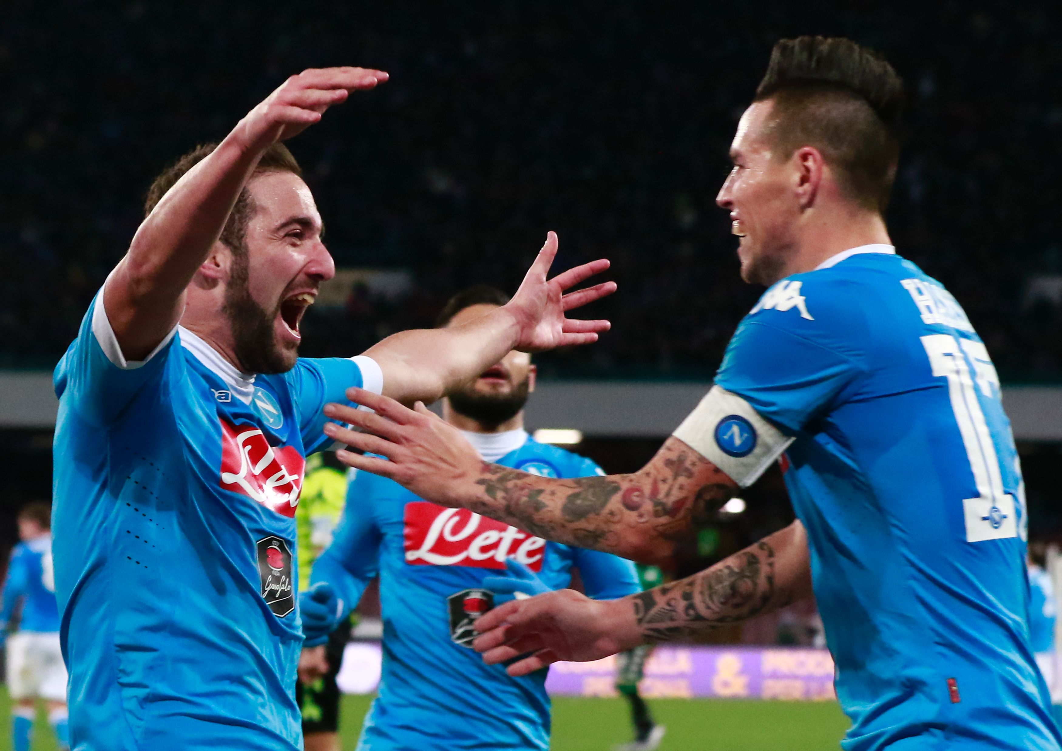 Napoli's Argentinian forward Gonzalo Higuain (L) celebrates with Napoli's Slovak forward Marek Hamsik after scoring a goal during the Italian Serie A football match Napoli and Sassuolo Calcio at the San Paolo stadium in Naples on January 16, 2016. / AFP / CARLO HERMANN        (Photo credit should read CARLO HERMANN/AFP/Getty Images)