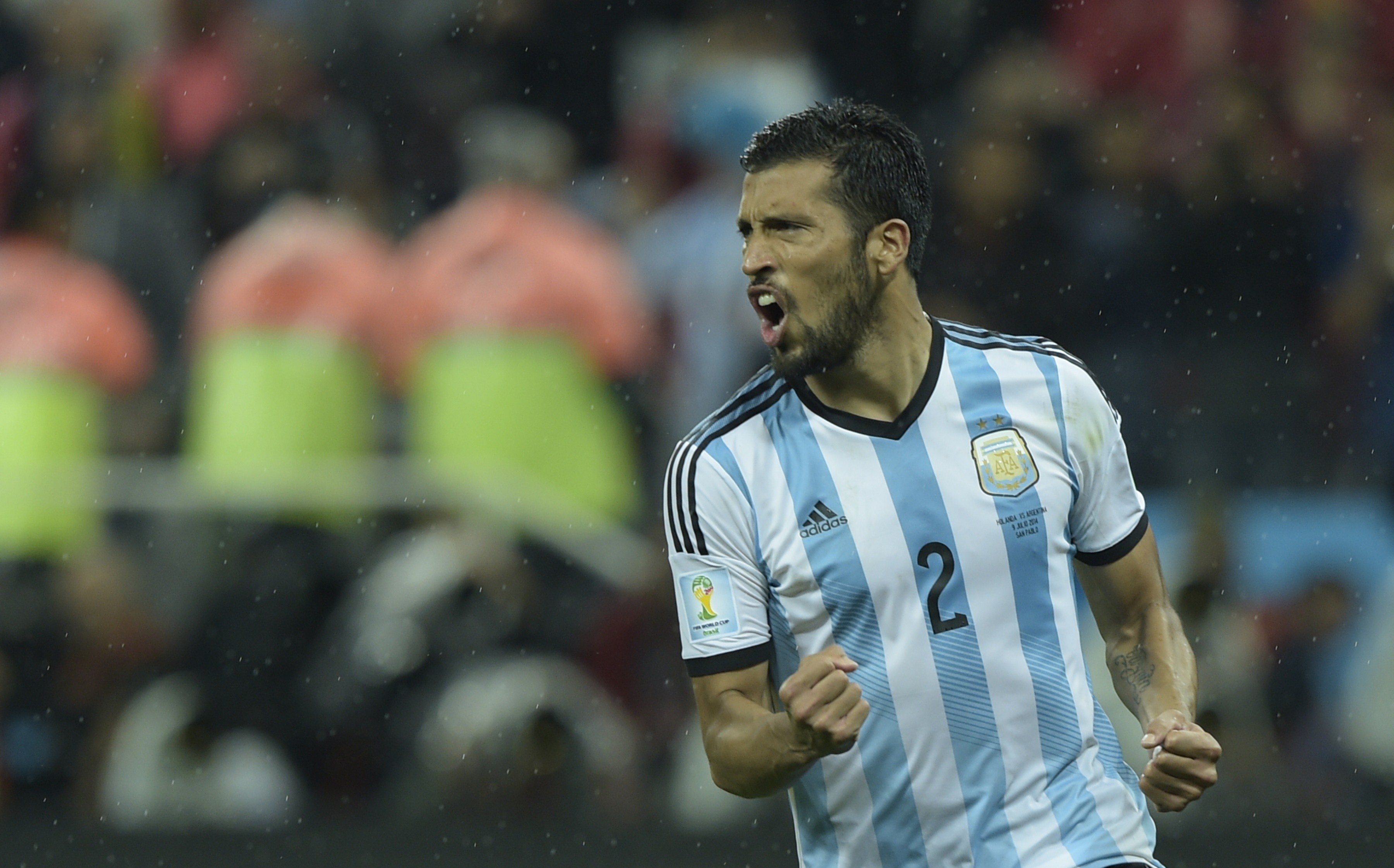 Argentina's defender Ezequiel Garay calabrates after scoring during penalty shoot-outs following extra time during the semi-final football match between Netherlands and Argentina of the FIFA World Cup at The Corinthians Arena in Sao Paulo on July 9, 2014.  AFP PHOTO / JUAN MABROMATA        (Photo credit should read JUAN MABROMATA/AFP/Getty Images)