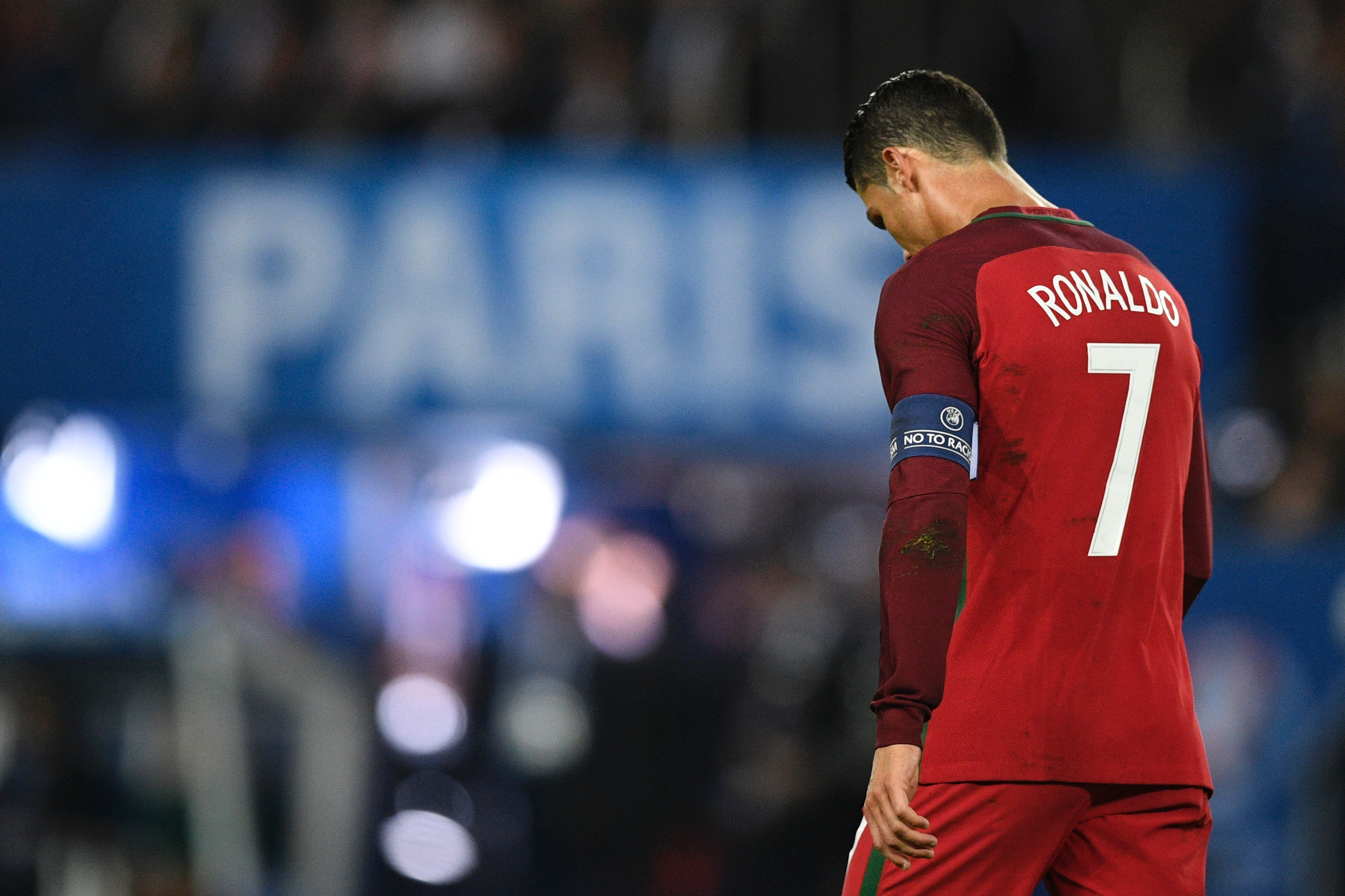 TOPSHOT - Portugal's forward Cristiano Ronaldo reacts after he missed to score a penalty during the Euro 2016 group F football match between Portugal and Austria at the Parc des Princes in Paris on June 18, 2016. / AFP / MARTIN BUREAU        (Photo credit should read MARTIN BUREAU/AFP/Getty Images)