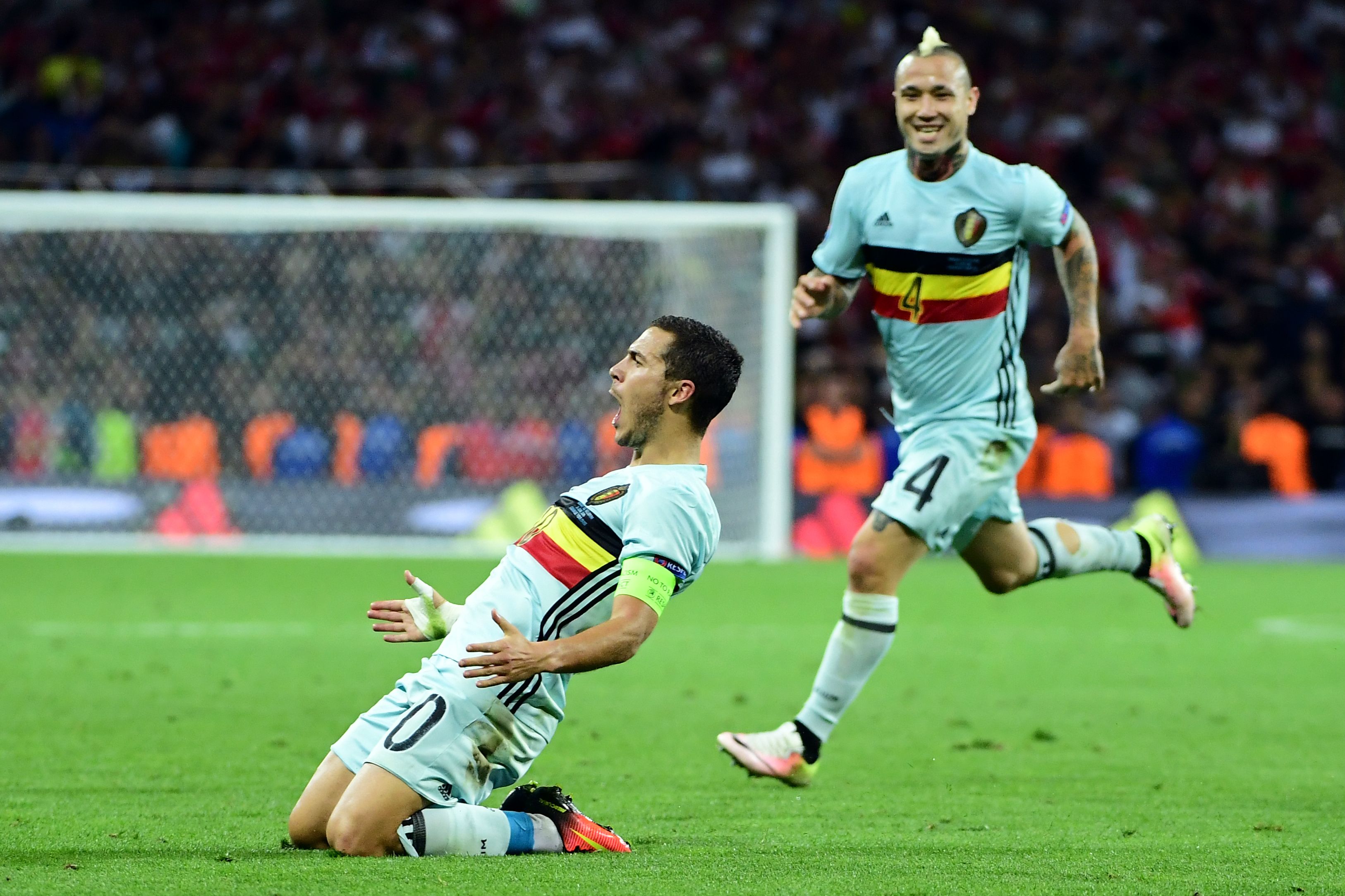 TOPSHOT - Belgium's forward Eden Hazard (L) celebrates after scoring his team's third goal  during the Euro 2016 round of 16 football match between Hungary and Belgium at the Stadium Municipal in Toulouse on June 26, 2016.   / AFP / EMMANUEL DUNAND        (Photo credit should read EMMANUEL DUNAND/AFP/Getty Images)