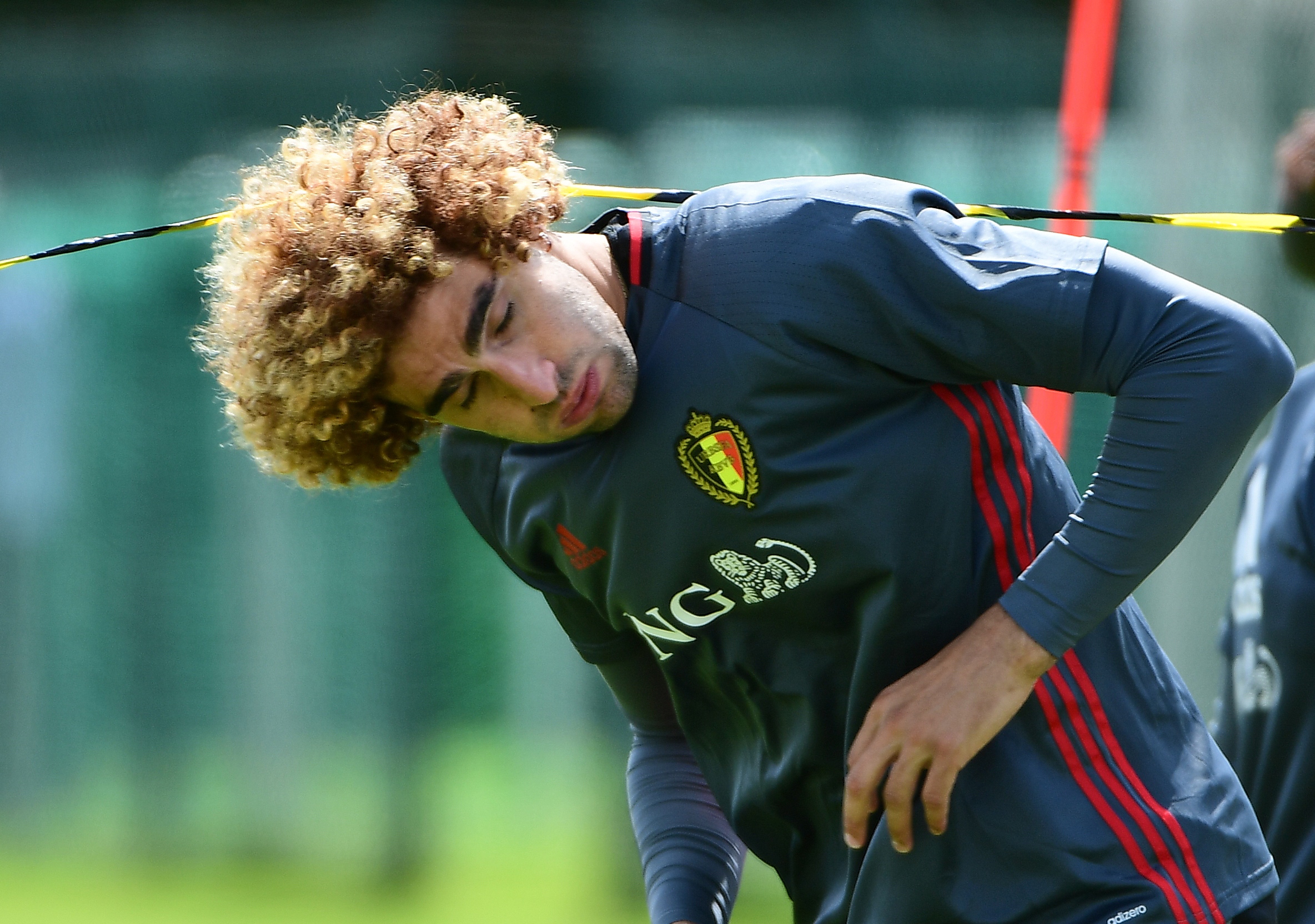 Belgium's midfielder Marouane Fellaini attends a training session in Le Haillan during the Euro 2016 football tournament, on June 15, 2016.   / AFP / EMMANUEL DUNAND        (Photo credit should read EMMANUEL DUNAND/AFP/Getty Images)