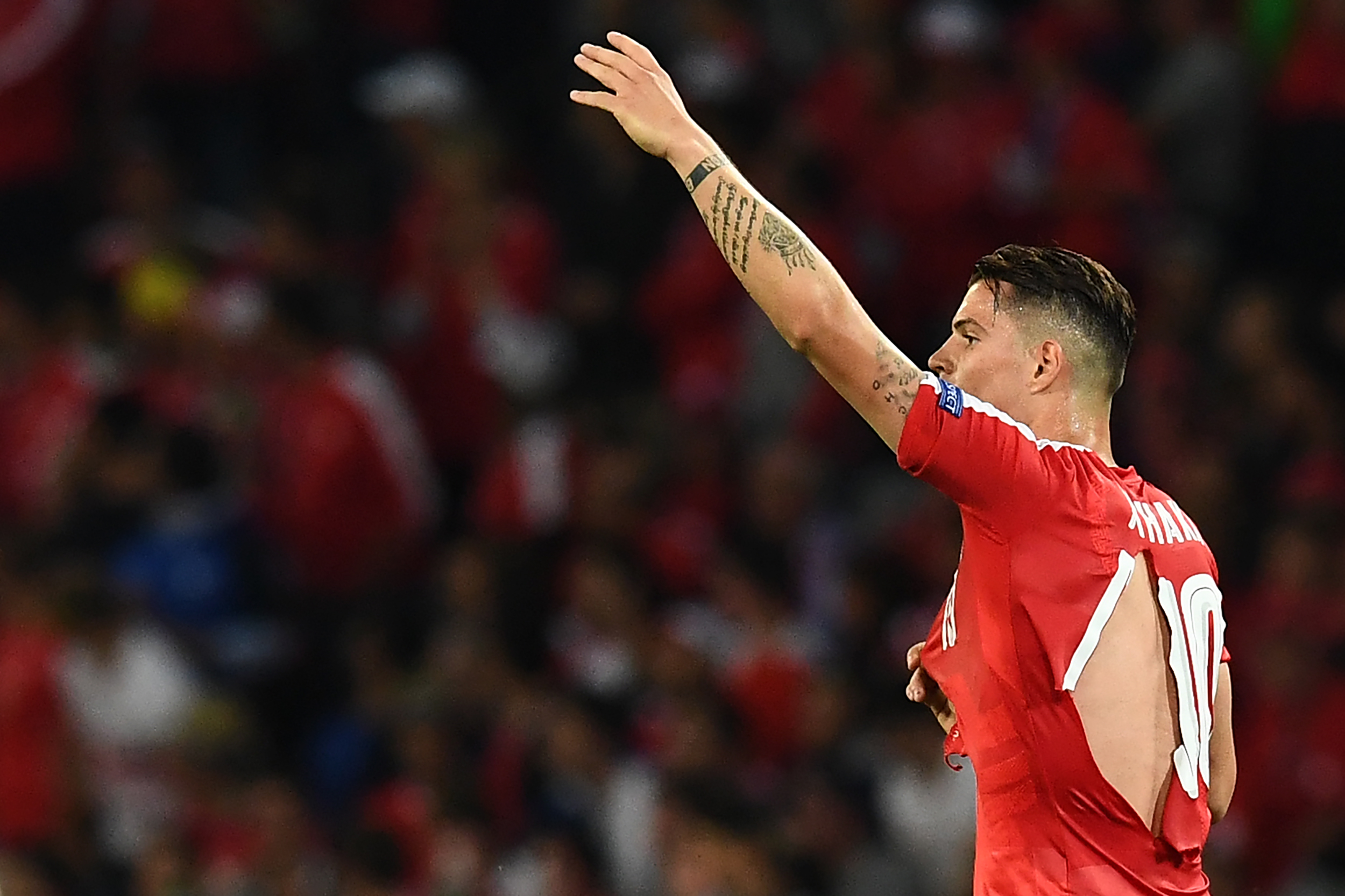 TOPSHOT - Switzerland's midfielder Granit Xhaka in a ripped shirt gestures during the Euro 2016 group A football match between Switzerland and France at the Pierre-Mauroy stadium in Lille on June 19, 2016. / AFP / FRANCK FIFE        (Photo credit should read FRANCK FIFE/AFP/Getty Images)