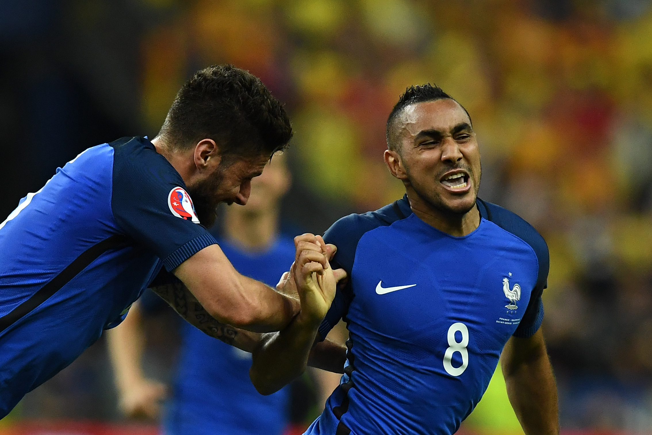 France's forward Dimitri Payet (R) celebrates with France's forward Olivier Giroud after scoring the 2-1 during the Euro 2016 group A football match between France and Romania at Stade de France, in Saint-Denis, north of Paris, on June 10, 2016. / AFP / FRANCK FIFE        (Photo credit should read FRANCK FIFE/AFP/Getty Images)