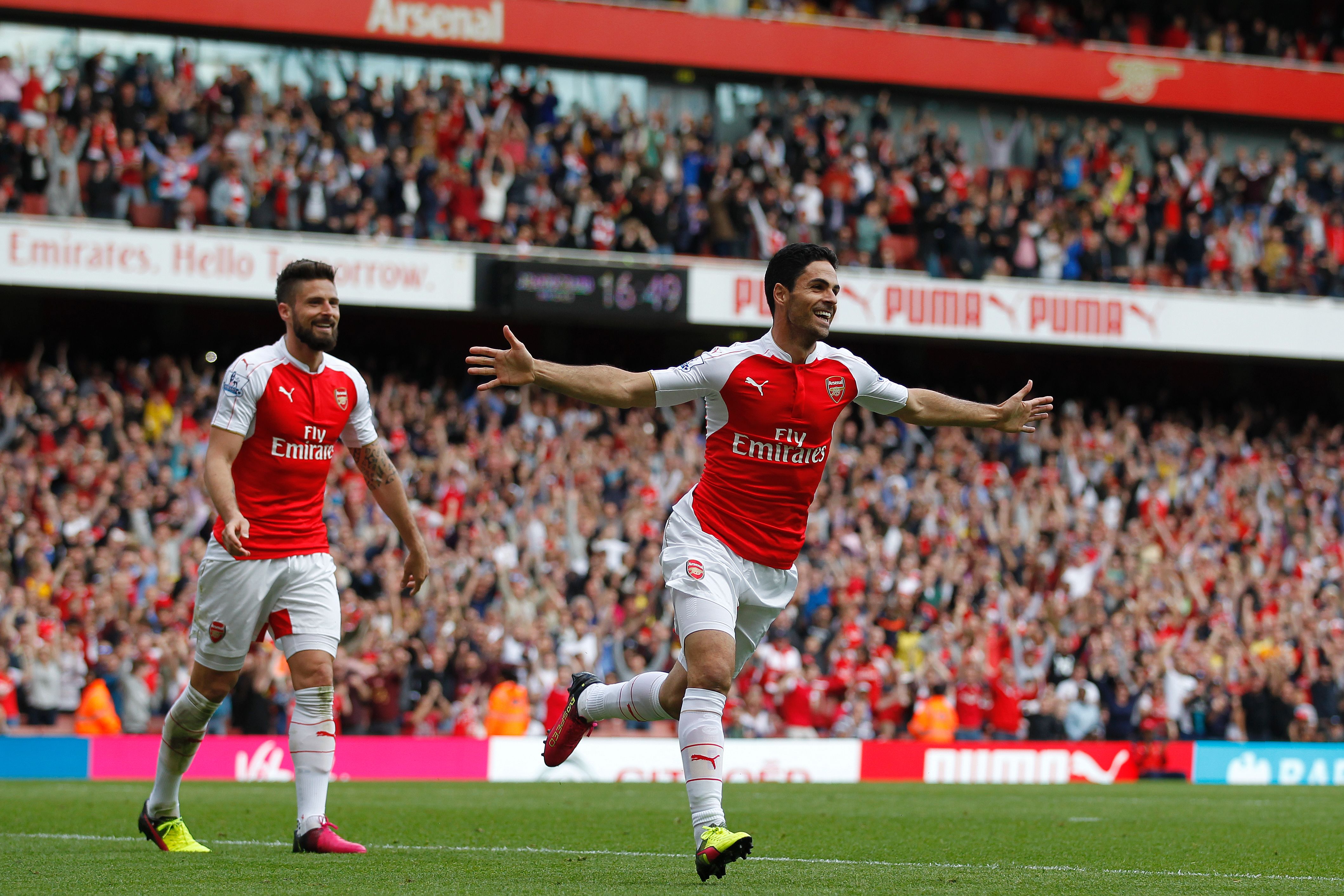 Arsenal's Spanish midfielder Mikel Arteta (R) celebrates scoring his team's fourth goal with Arsenal's French striker Olivier Giroud during the English Premier League football match between Arsenal and Aston Villa at the Emirates Stadium in London on May 15, 2016.  / AFP / Ian Kington / RESTRICTED TO EDITORIAL USE. No use with unauthorized audio, video, data, fixture lists, club/league logos or 'live' services. Online in-match use limited to 75 images, no video emulation. No use in betting, games or single club/league/player publications.  /         (Photo credit should read IAN KINGTON/AFP/Getty Images)