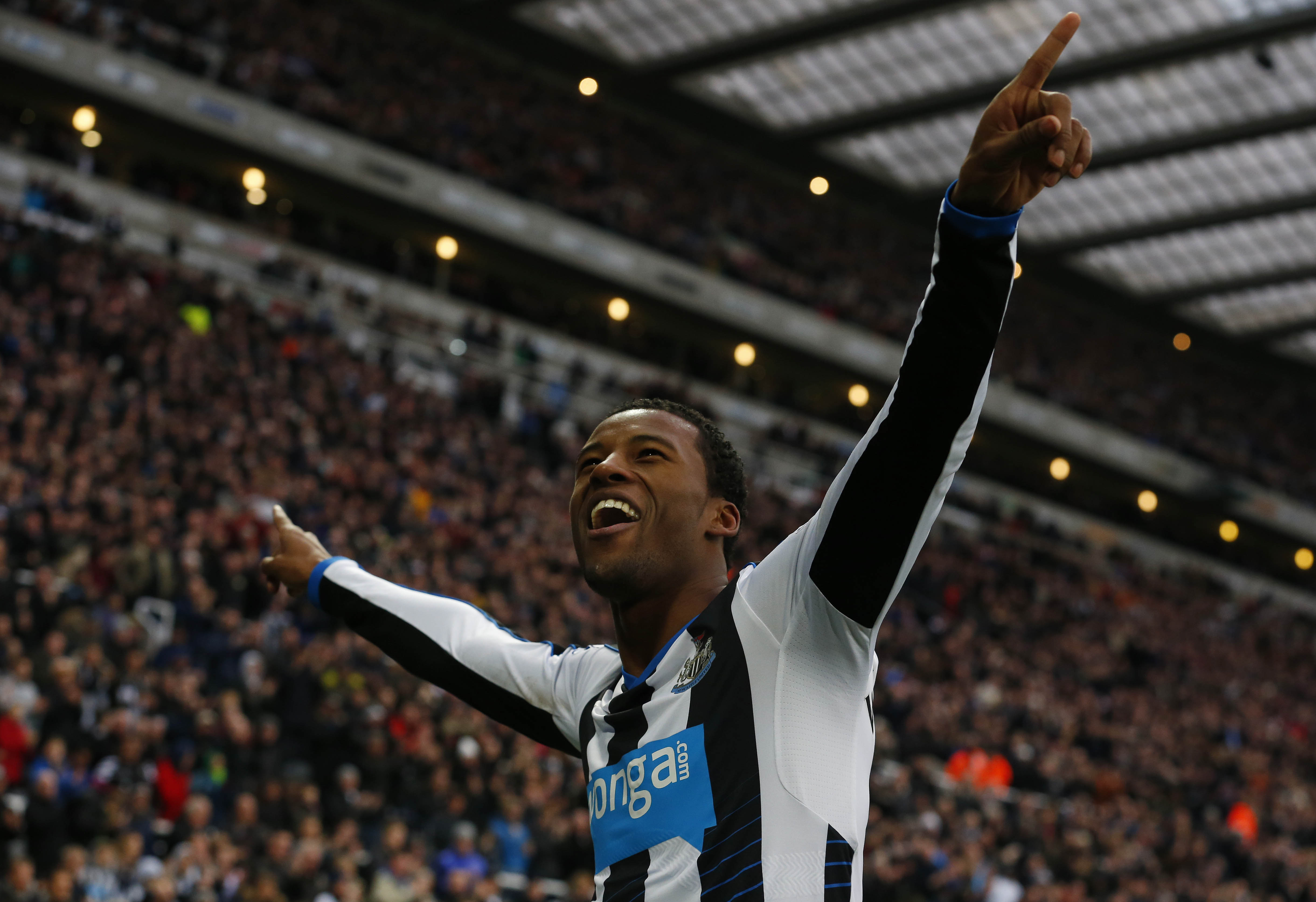 Newcastle United's Dutch midfielder Georginio Wijnaldum (R) celebrates scoring his team's second goal during the English Premier League football match between Newcastle United and West Ham United at St James' Park in Newcastle-upon-Tyne, north east England on January 16, 2016.  AFP PHOTO / LINDSEY PARNABY

RESTRICTED TO EDITORIAL USE. No use with unauthorized audio, video, data, fixture lists, club/league logos or 'live' services. Online in-match use limited to 75 images, no video emulation. No use in betting, games or single club/league/player publications. / AFP / LINDSEY PARNABY        (Photo credit should read LINDSEY PARNABY/AFP/Getty Images)