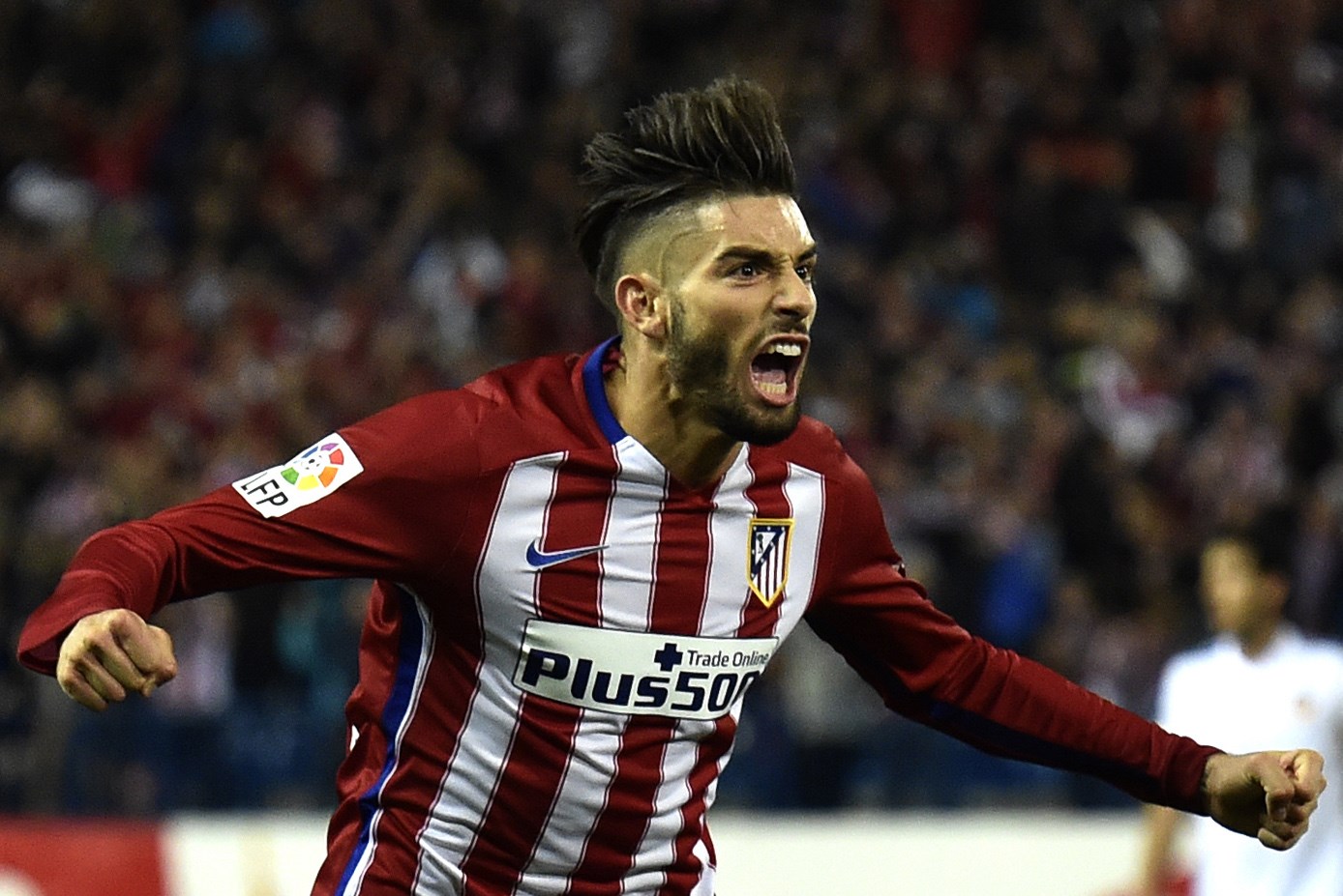 Atletico Madrid's Belgian midfielder Yannick Ferreira Carrasco celebrates a goal during the Spanish league football match Club Atletico de Madrid vs Valencia CF at the Vicente Calderon stadium in Madrid on October 25, 2015.   AFP PHOTO/ GERARD JULIEN        (Photo credit should read GERARD JULIEN/AFP/Getty Images)