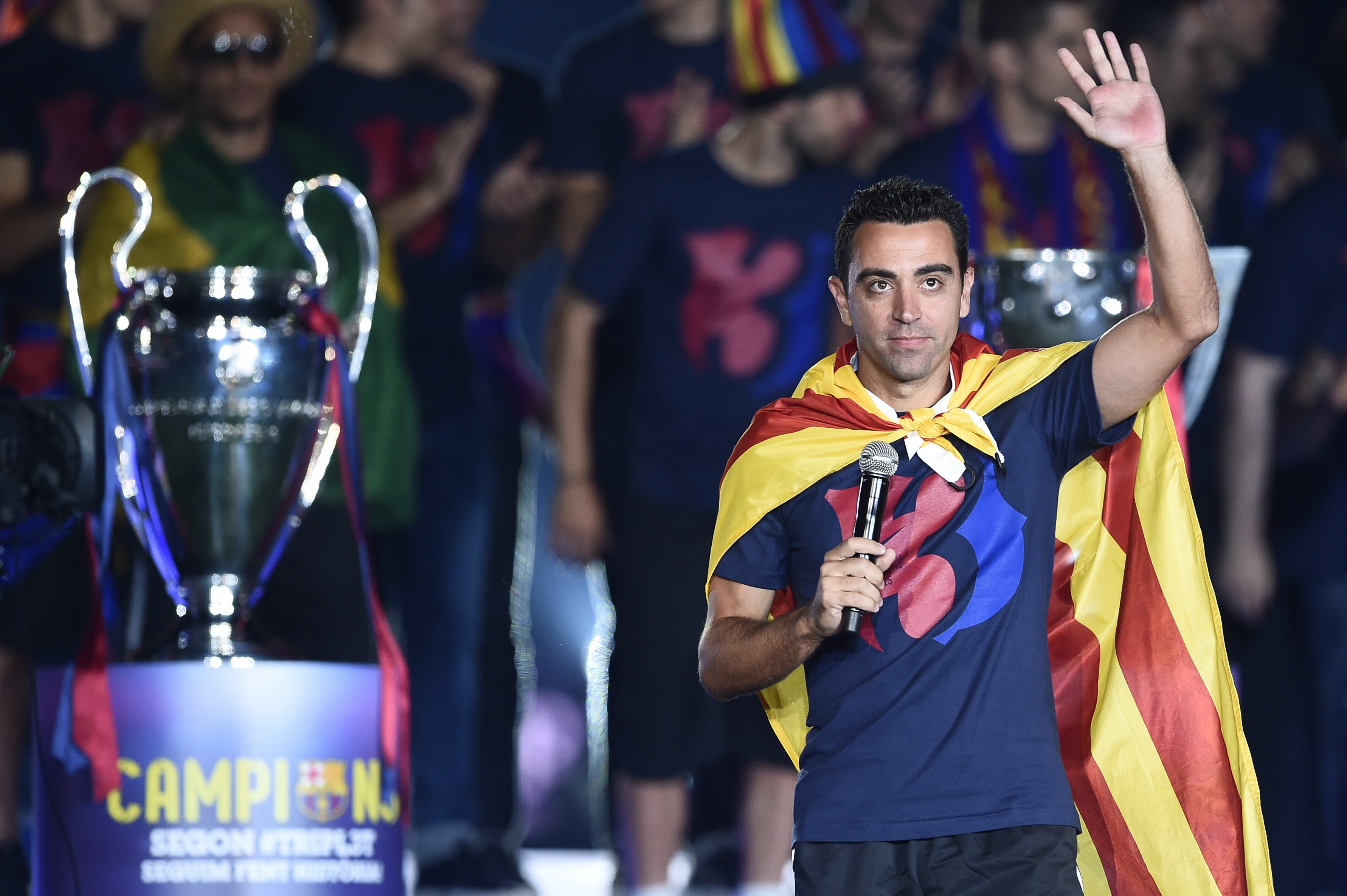 Barcelona's midfielder Xavi Hernandez waves as he takes part in the celebrations held for their victory over Juventus, one day after the UEFA Champions League final football, at the Camp Nou stadium in Barcelona on June 7, 2015. Luis Suarez and Neymar scored second-half goals to give Barcelona a 3-1 Champions League final victory over Juventus on June 6, 2015 as the Spaniards became the first team to twice win the European treble.   AFP PHOTO/ JOSEP LAGO        (Photo credit should read JOSEP LAGO/AFP/Getty Images)
