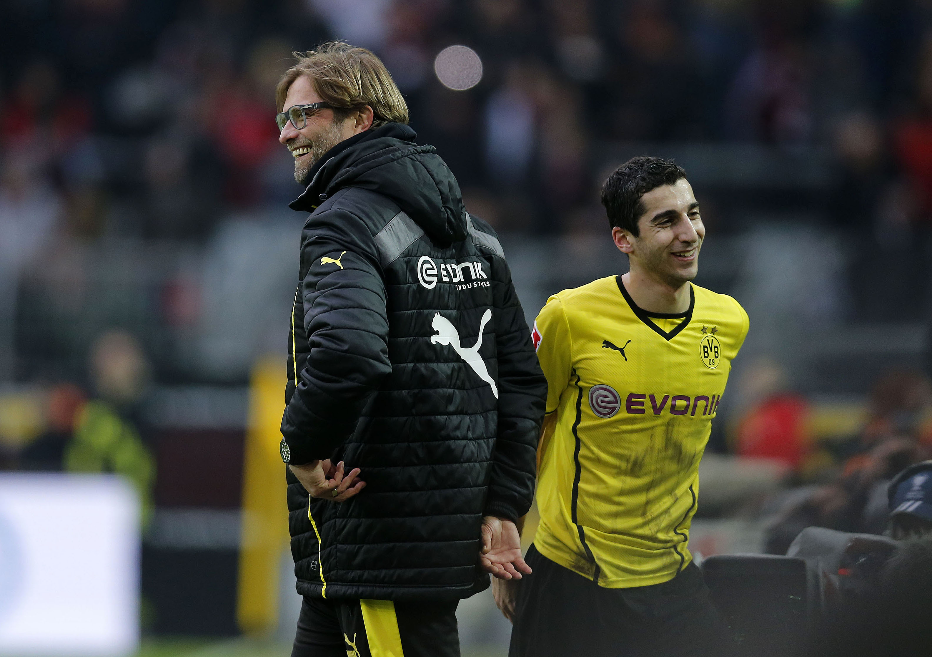 Dortmund's Armenian midfielder Henrikh Mkhitaryan walks past Dortmund's head coach Juergen Klopp (L) during the German first division Bundesliga football match Borussia Dortmund vs 1FC Nuernberg in Dortmund, western Germany, on March 1, 2014. (Photo by Norbert Schmidt/AFP)