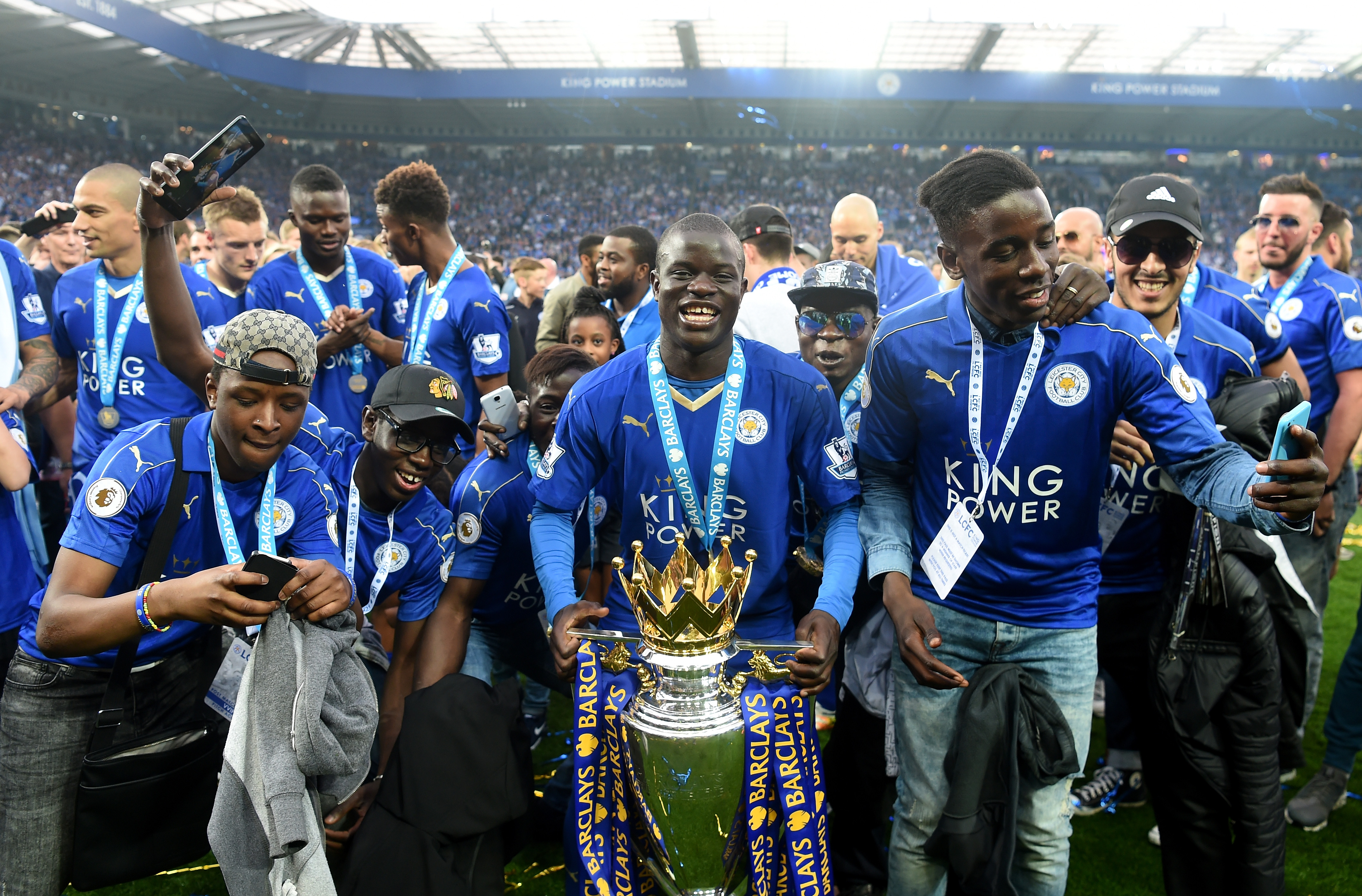 LEICESTER, ENGLAND - MAY 07:  Ngolo Kante of Leicester City poses with the Premier League Trophy with his family as players and staffs celebrate the season champion after the Barclays Premier League match between Leicester City and Everton at The King Power Stadium on May 7, 2016 in Leicester, United Kingdom.  (Photo by Michael Regan/Getty Images)