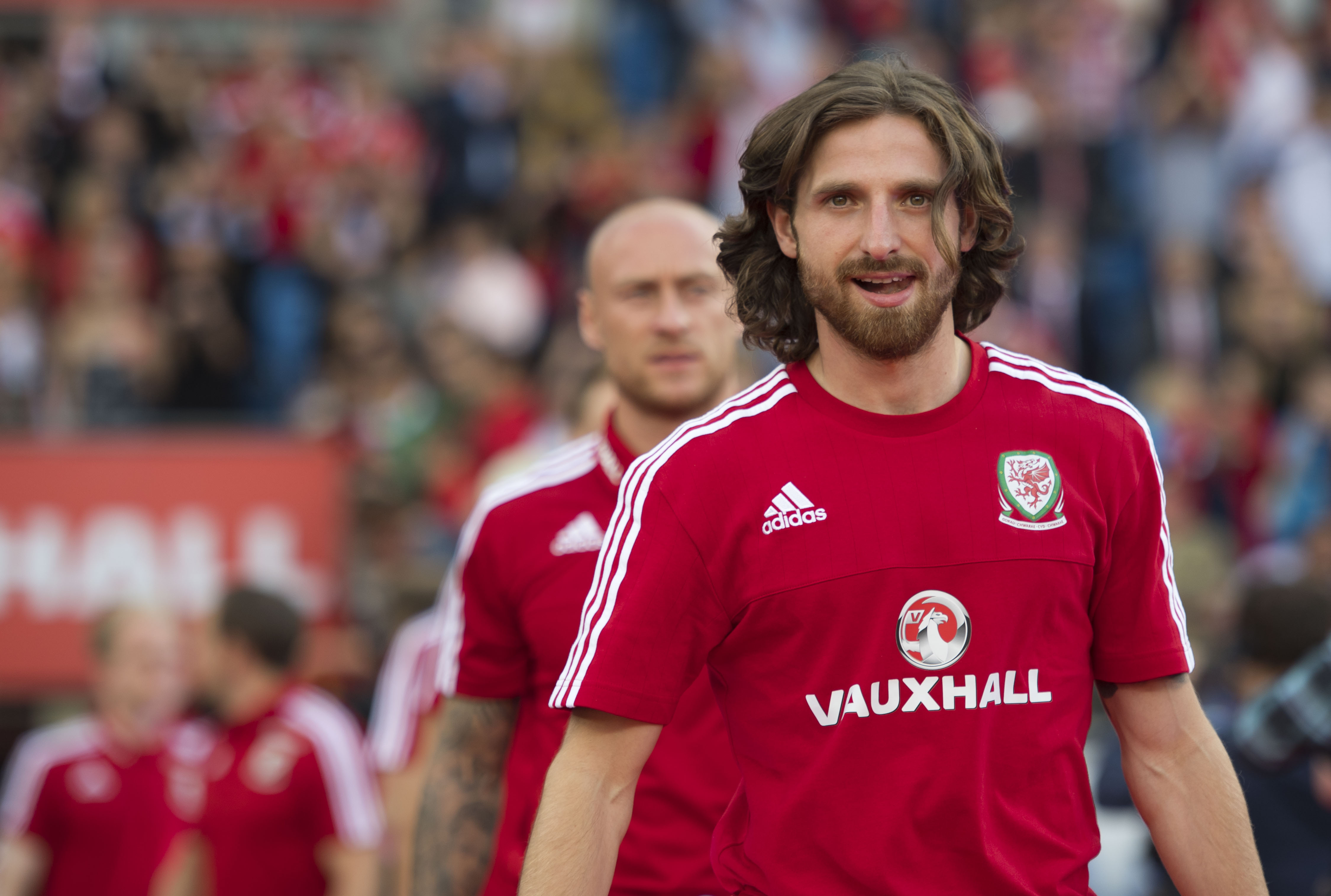 CARDIFF, WALES - JULY 08: Wales' Joe Allen walks onto the pitch during a ceremony at the Cardiff City Stadium on July 8, 2016 in Cardiff, Wales. The players toured the streets of Cardiff in an open top bus before arriving at the Cardiff City Stadium for an after party for which 33,000 tickets have been sold. Wales historic run in Euro 2016 saw them reach the semi-finals, before being knocked out 2-0 by Portugal at Stade de Lyon in France. (Photo by Matthew Horwood/Getty Images)