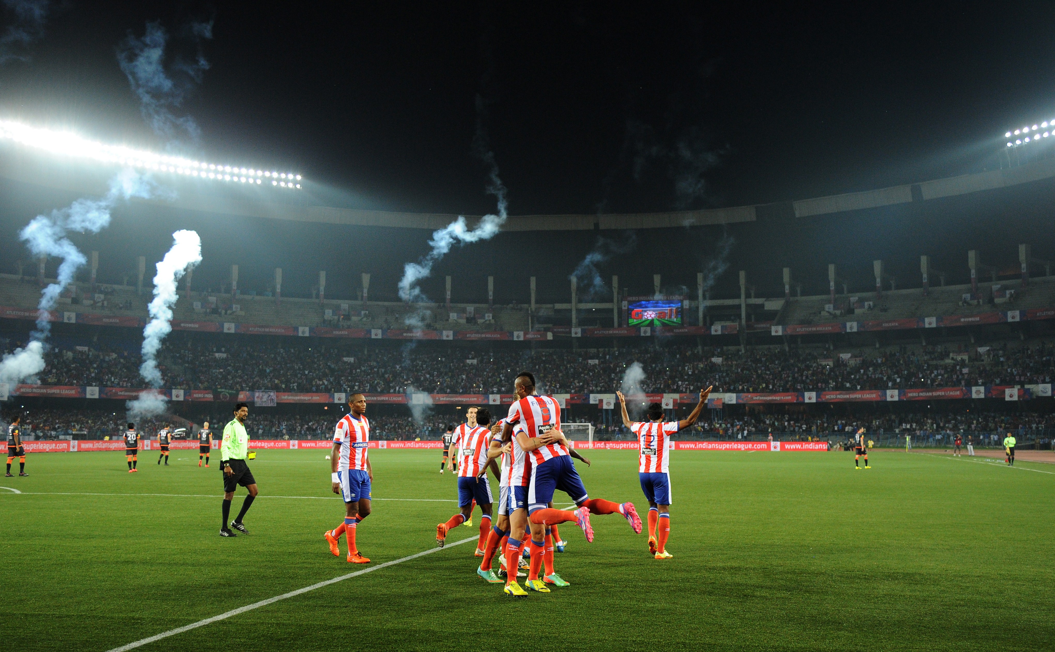 Atletico de Kolkata footballers celebrate a goal by teammate Joffre Gonzalez during the Indian Super League (ISL) football match between Atletico de Kolkata and Delhi Dynamos FC at The Salt Lake Stadium in Kolkata on October 19, 2014. AFP PHOTO/Dibyangshu SARKAR        (Photo credit should read DIBYANGSHU SARKAR/AFP/Getty Images)