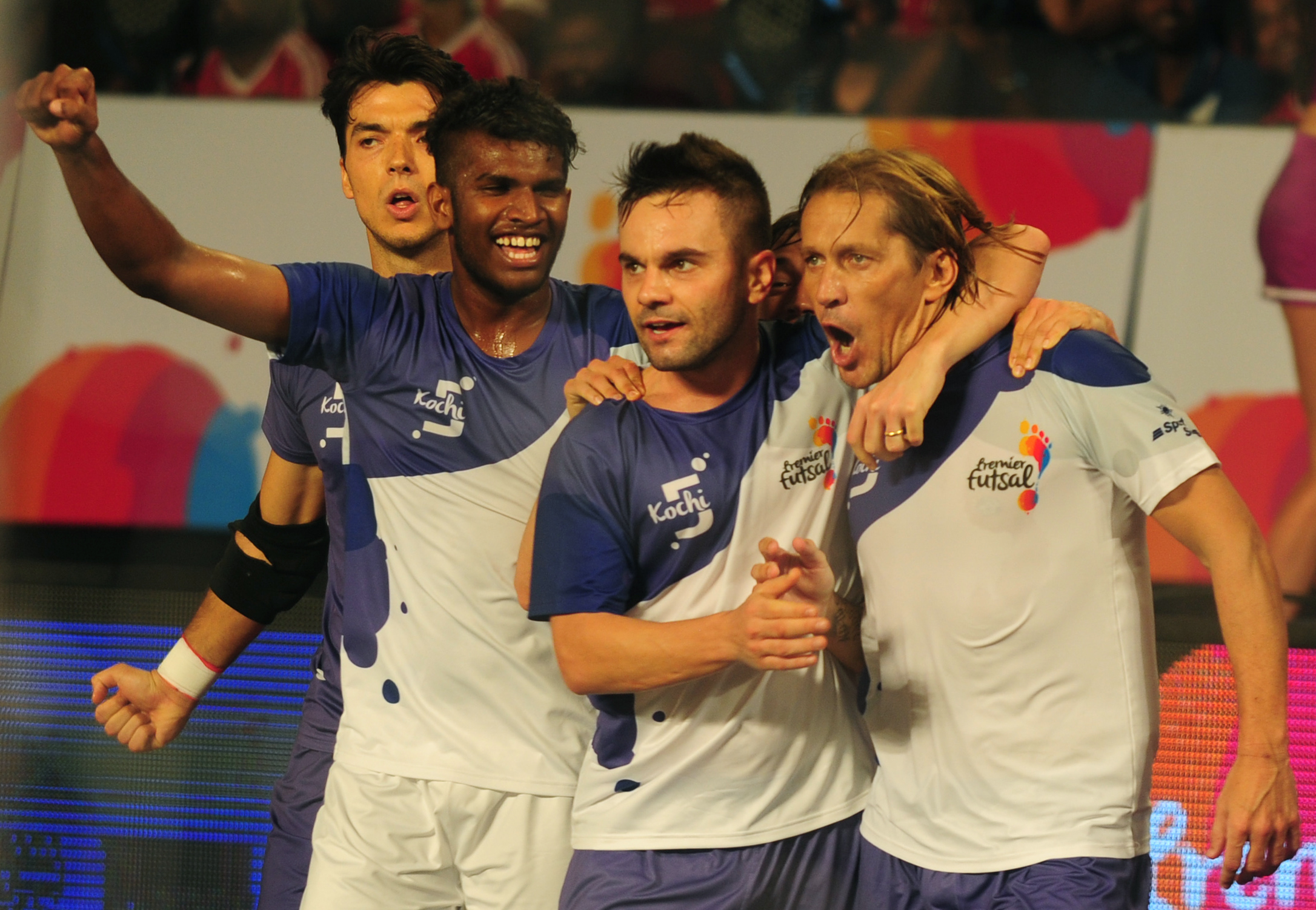 Kochi's Miguel Salgado (R) celebrates after scoring a goal against the Mumbai 5's during their Premier Futsal Football League match in Chennai on July 16, 2016. / AFP / ARUN SANKAR        (Photo credit should read ARUN SANKAR/AFP/Getty Images)