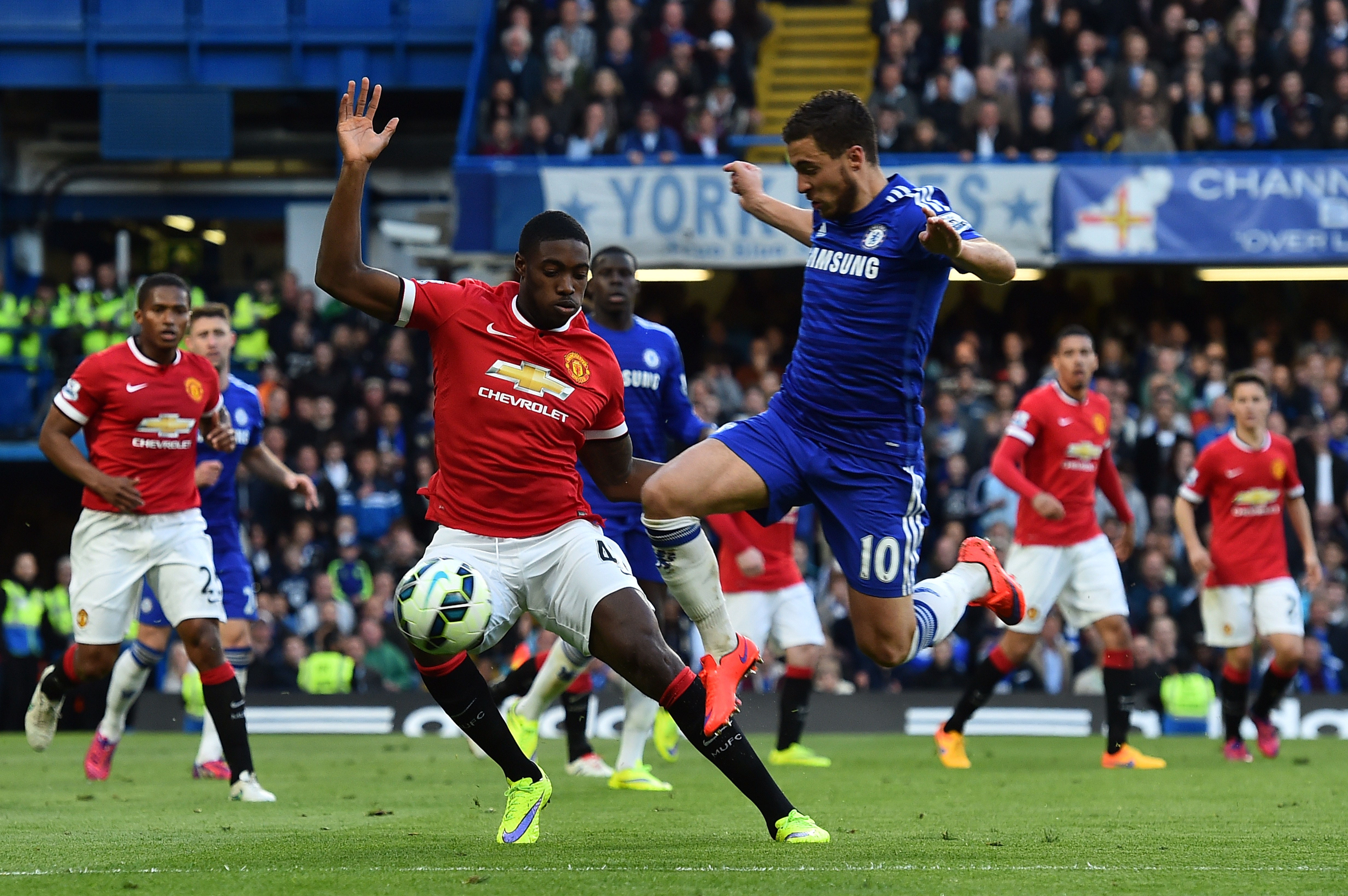 Chelsea's Belgian midfielder Eden Hazard (3R) tries to get past Manchester United's English defender Tyler Blackett (2L) during the English Premier League football match between Chelsea and Manchester United at Stamford Bridge in London on April 18, 2015. AFP PHOTO / BEN STANSALL

RESTRICTED TO EDITORIAL USE. No use with unauthorized audio, video, data, fixture lists, club/league logos or live services. Online in-match use limited to 45 images, no video emulation. No use in betting, games or single club/league/player publications.        (Photo credit should read BEN STANSALL/AFP/Getty Images)