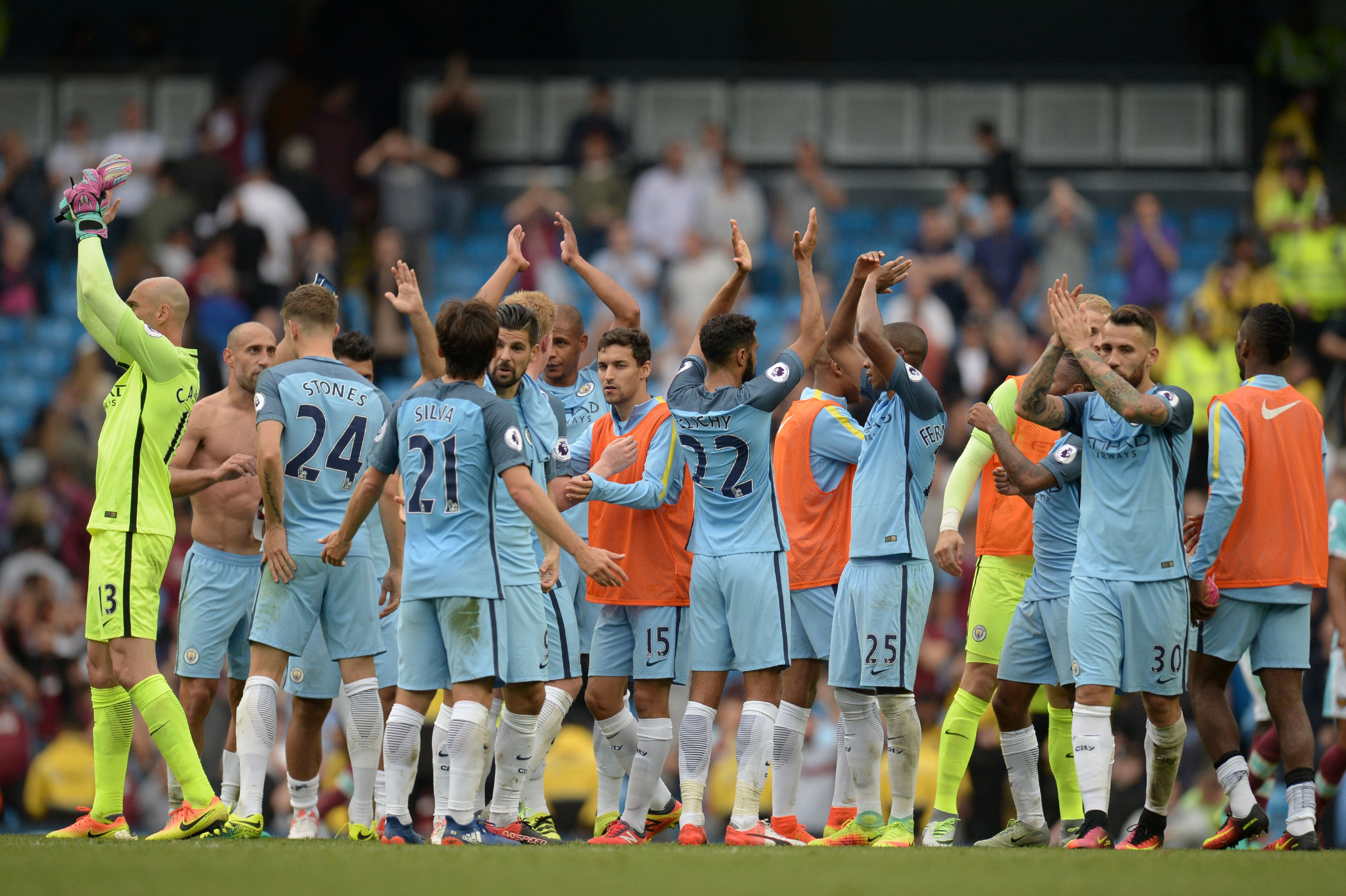 Manchester City players celebrate after winning the English Premier League football match between Manchester City and West Ham United at the Etihad Stadium in Manchester, north west England, on August 28, 2016. / AFP / OLI SCARFF / RESTRICTED TO EDITORIAL USE. No use with unauthorized audio, video, data, fixture lists, club/league logos or 'live' services. Online in-match use limited to 75 images, no video emulation. No use in betting, games or single club/league/player publications.  /         (Photo credit should read OLI SCARFF/AFP/Getty Images)