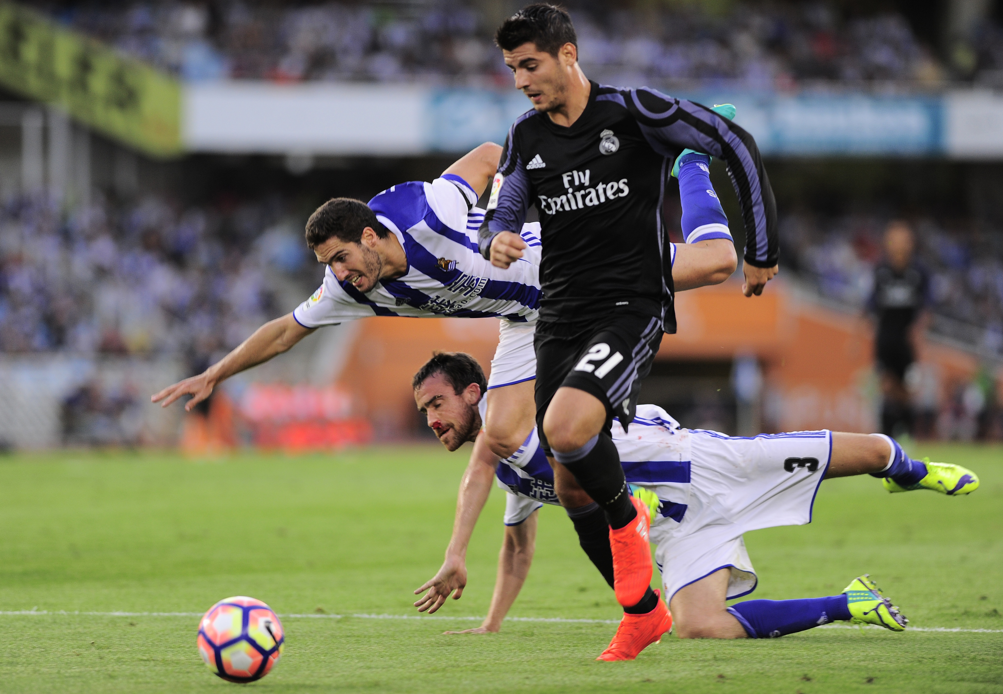 Real Madrid's forward Alvaro Borja Morata (R) vies with Real Sociedad's defender Mikel Gonzalez (C) and  defender Joseba Zaldua (L) during the Spanish league football match Real Sociedad vs Real Madrid CF at the Anoeta stadium in San Sebastian on August 21, 2016. / AFP / ANDER GILLENEA        (Photo credit should read ANDER GILLENEA/AFP/Getty Images)