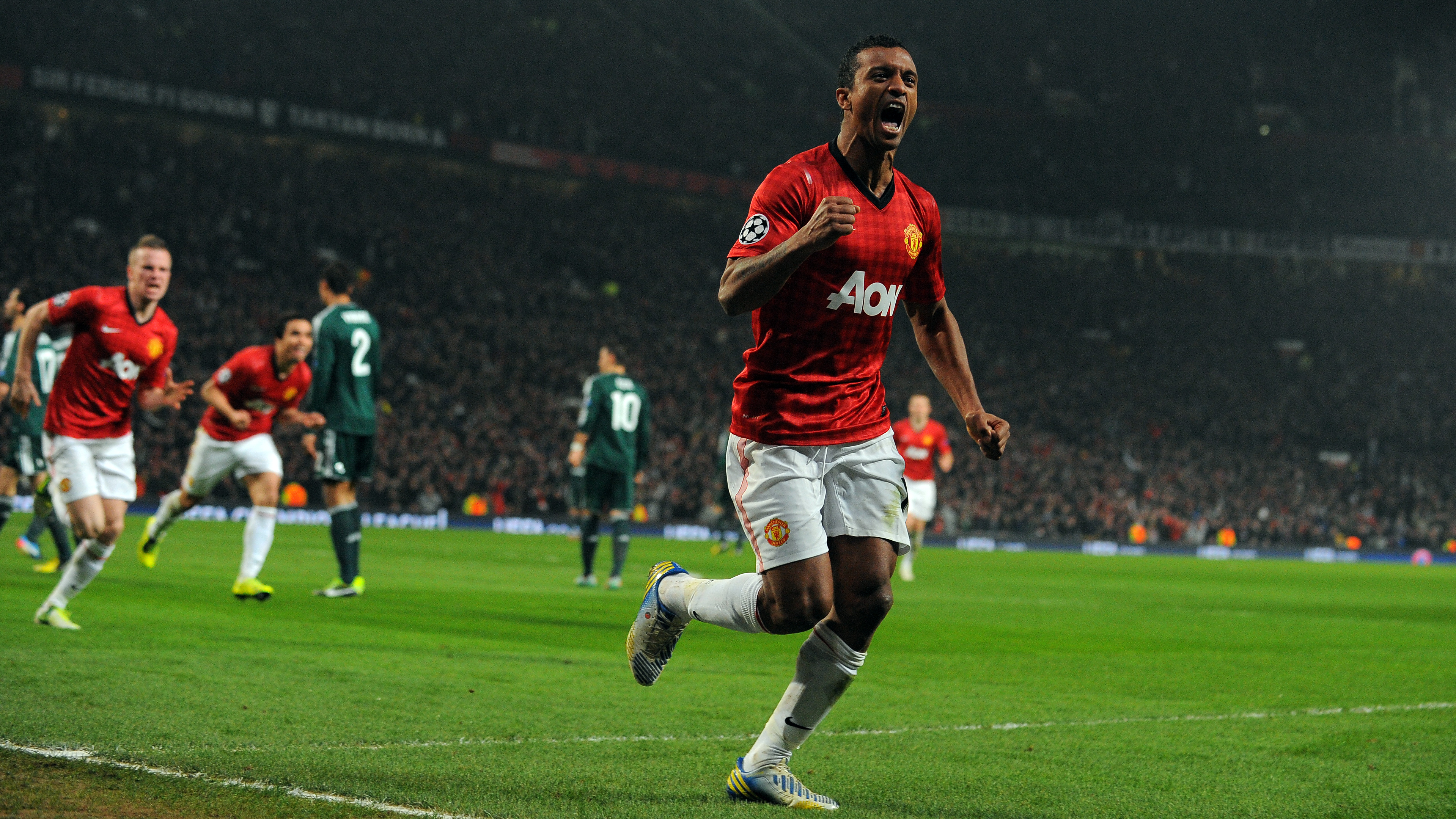 Manchester United's Portuguese midfielder Nani celebrates after Real Madrid's Spanish defender Sergio Ramos (unseen) scored an own goal during the UEFA Champions League round of 16 second leg football match between Manchester United and Real Madrid at Old Trafford in Manchester, northwest England on March 5, 2013. AFP PHOTO / ANDREW YATES        (Photo credit should read ANDREW YATES/AFP/Getty Images)