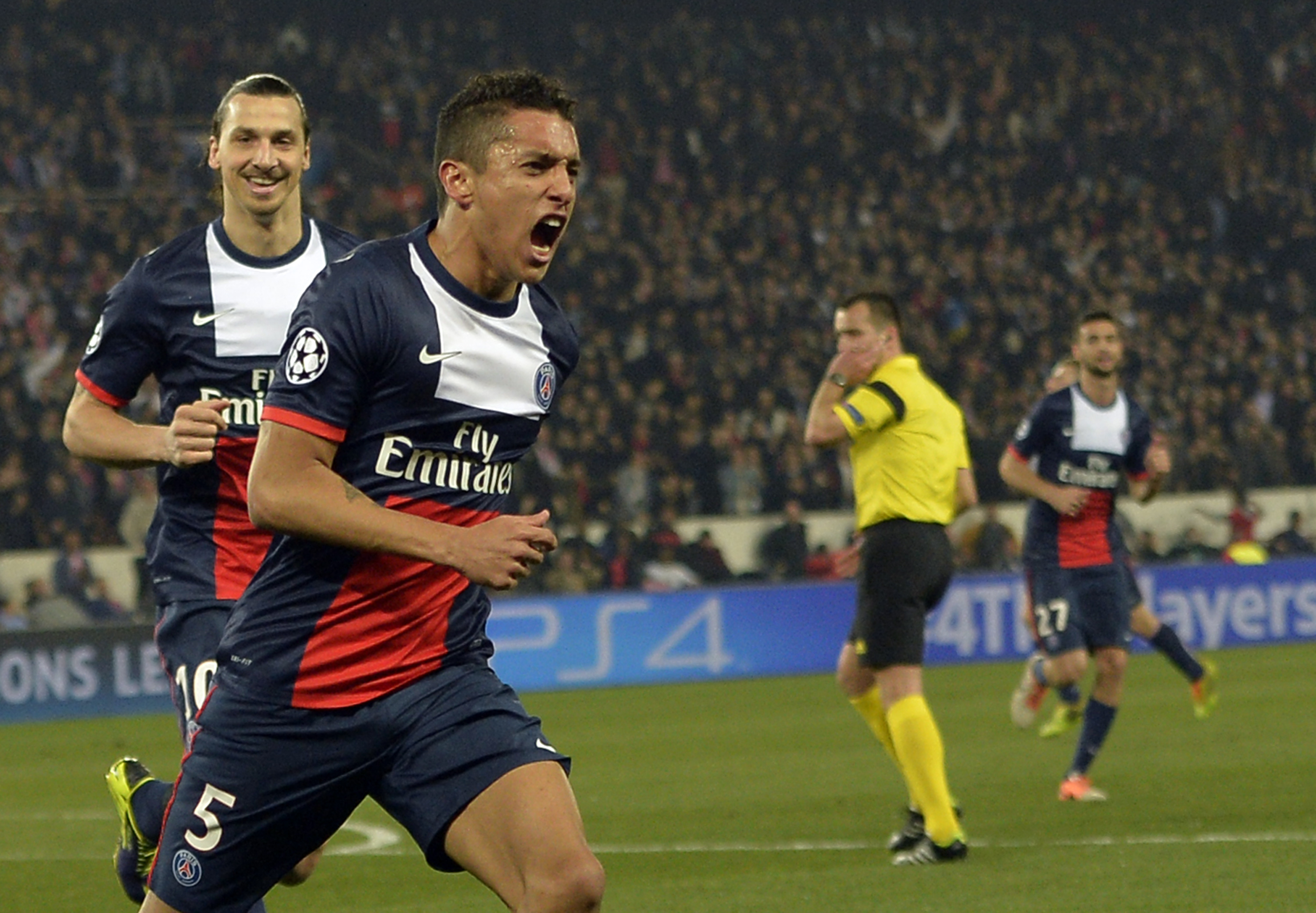 Paris' Brazilian defender Marquinhos celebrates after scoring during the UEFA Champions League last 16 second-leg football match between Paris Saint Germain and Bayer Leverkusen on March 12, 2014 in Paris.    AFP PHOTO / MIGUEL MEDINA        (Photo credit should read MIGUEL MEDINA/AFP/Getty Images)