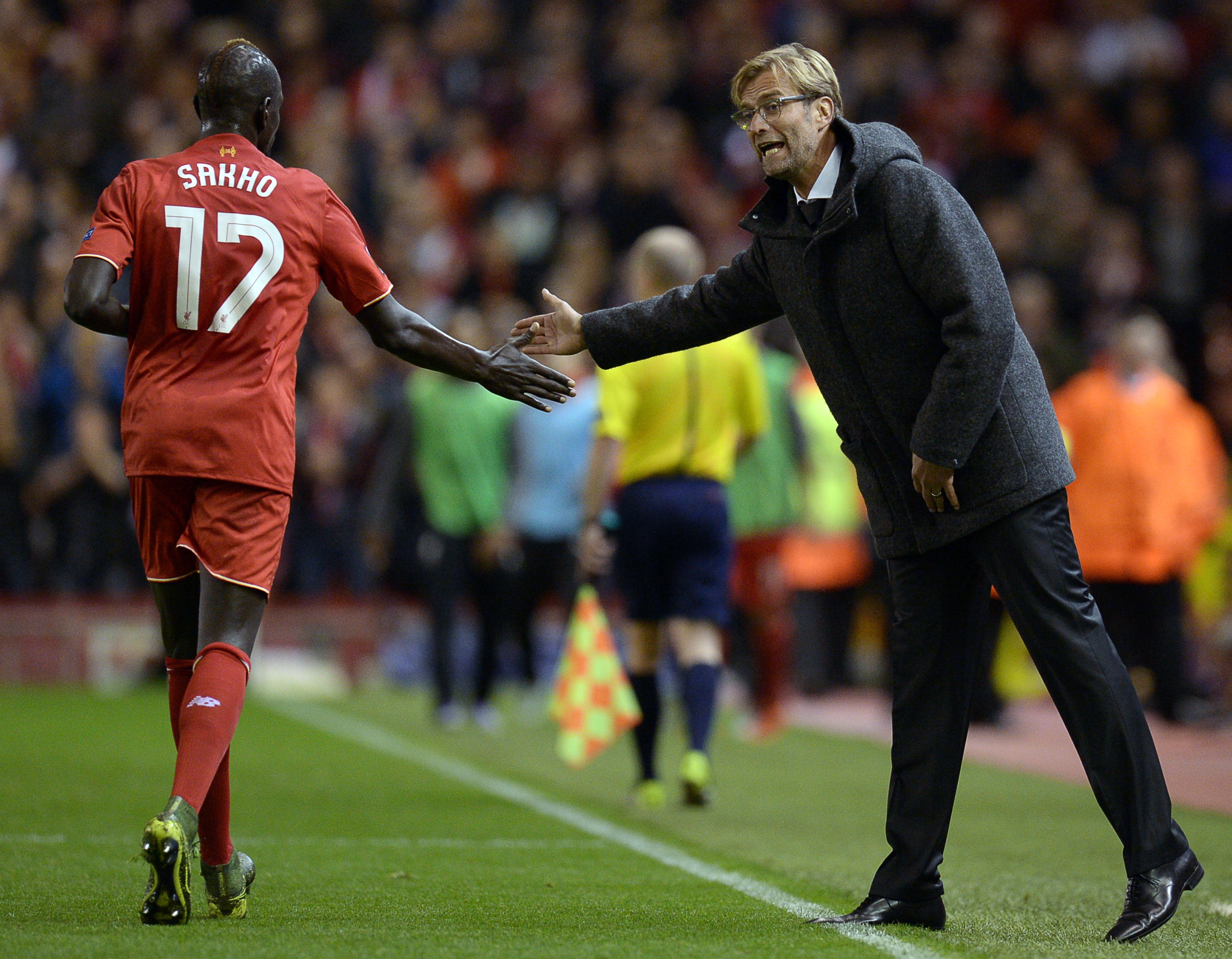 Liverpool's German manager  Jurgen Klopp (R) taps hands with Liverpool's French defender Mamadou Sakho  during a UEFA Europa League group B football match between Liverpool FC and FC Rubin Kazan at Anfield in Liverpool, north west England, on October 22, 2015.  AFP PHOTO / OLI SCARFF        (Photo credit should read OLI SCARFF/AFP/Getty Images)