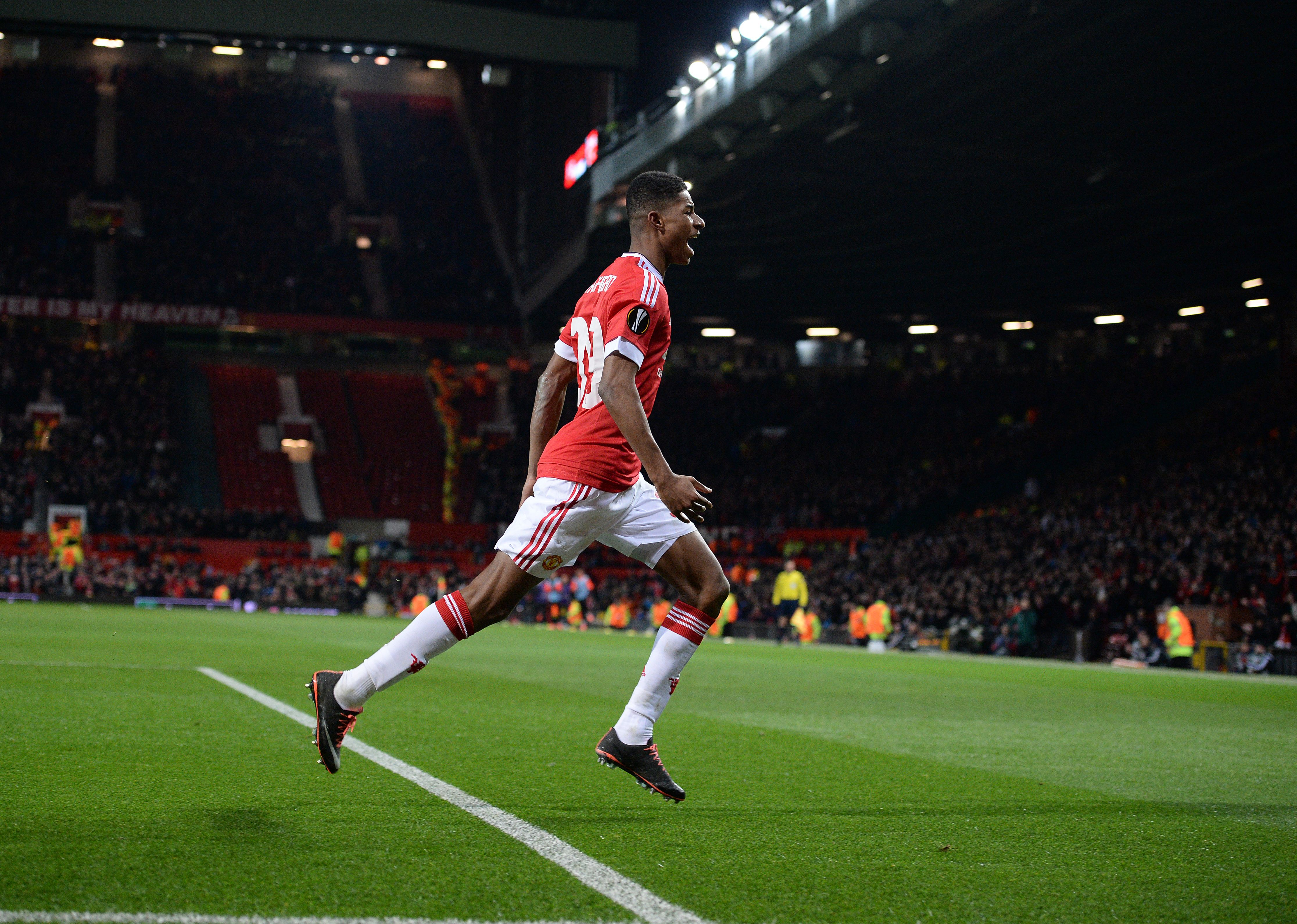 Manchester United's English striker Marcus Rashford (C) celebrates scoring his team's second goal during the UEFA Europa League round of 32, second leg football match between Manchester United and and FC Midtjylland at Old Trafford in Manchester, north west England, on February 25, 2016. 
 / AFP / OLI SCARFF        (Photo credit should read OLI SCARFF/AFP/Getty Images)