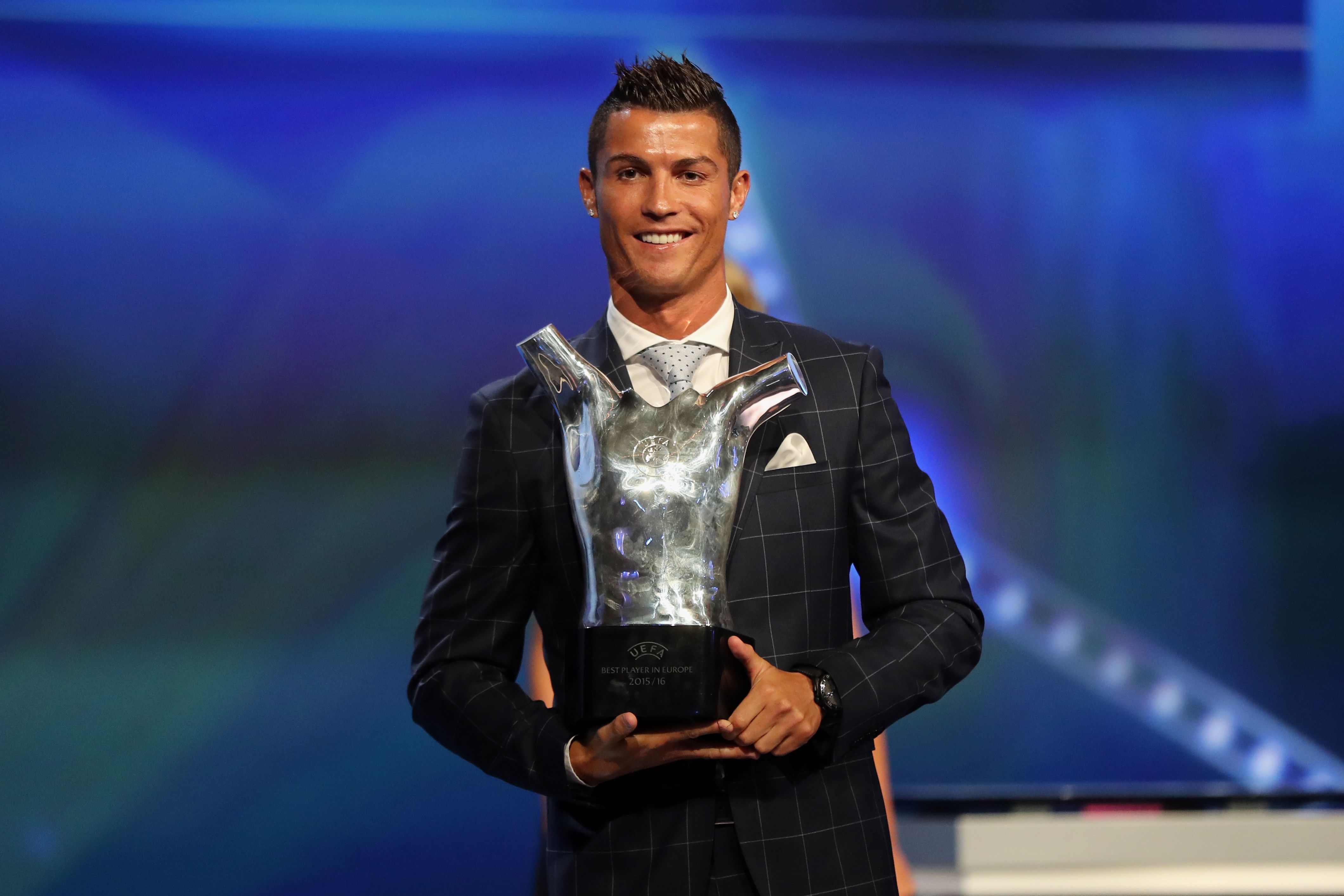 Real Madrid's Portuguese forward Cristiano Ronaldo holds his trophy of Best Men's player in Europe at the end of the UEFA Champions League Group stage draw ceremony, on August 25, 2016 in Monaco. (Photo credit: Valery Hache/AFP/Getty Images)