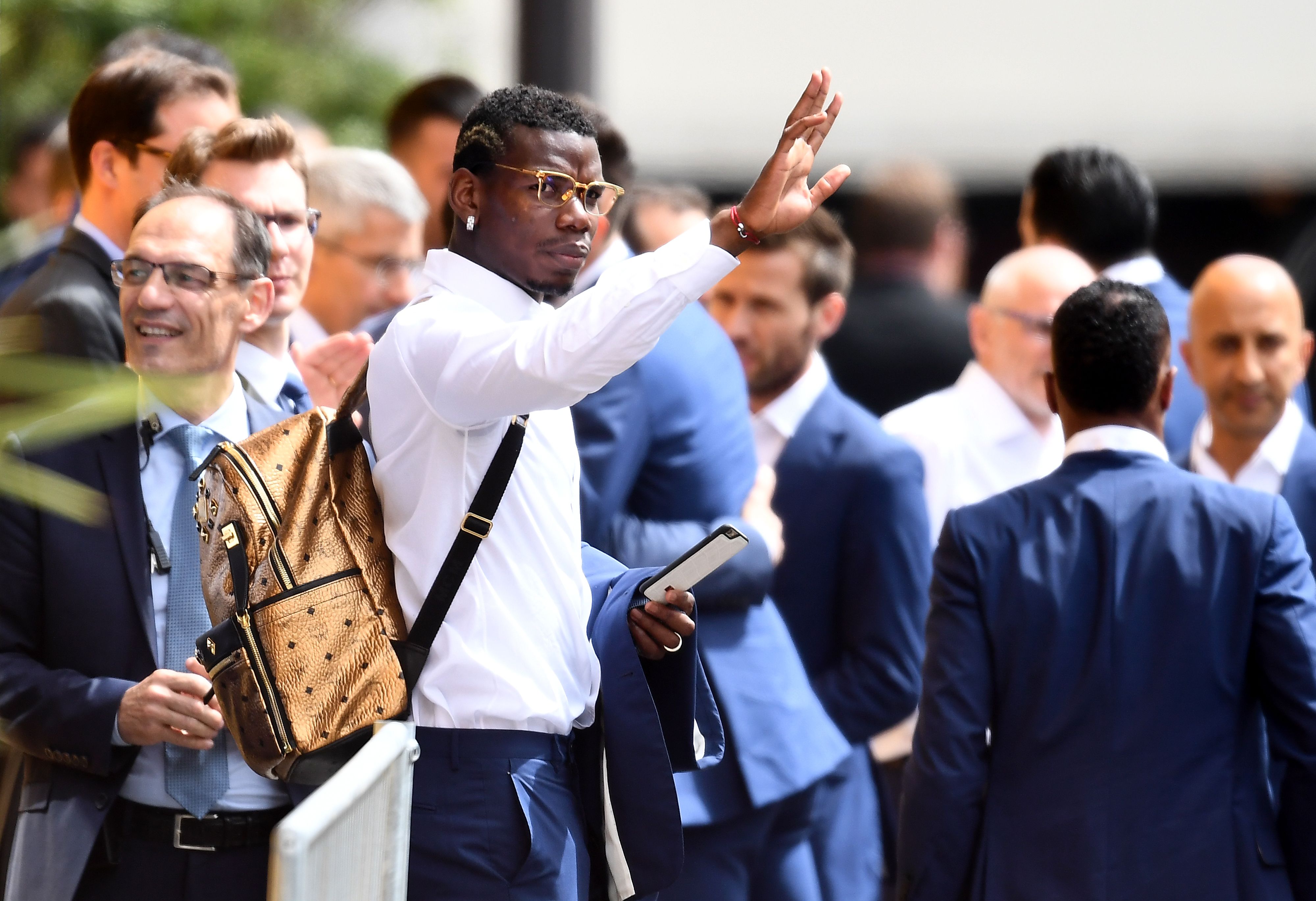 France's midfielder Paul Pogba waves at supporters as France's national football team players leave their hotel on their way to the Elysee Palace in Paris on July 11, 2016, a day after Portugal beat France in the Euro 2016 final football match. / AFP / FRANCK FIFE        (Photo credit should read FRANCK FIFE/AFP/Getty Images)