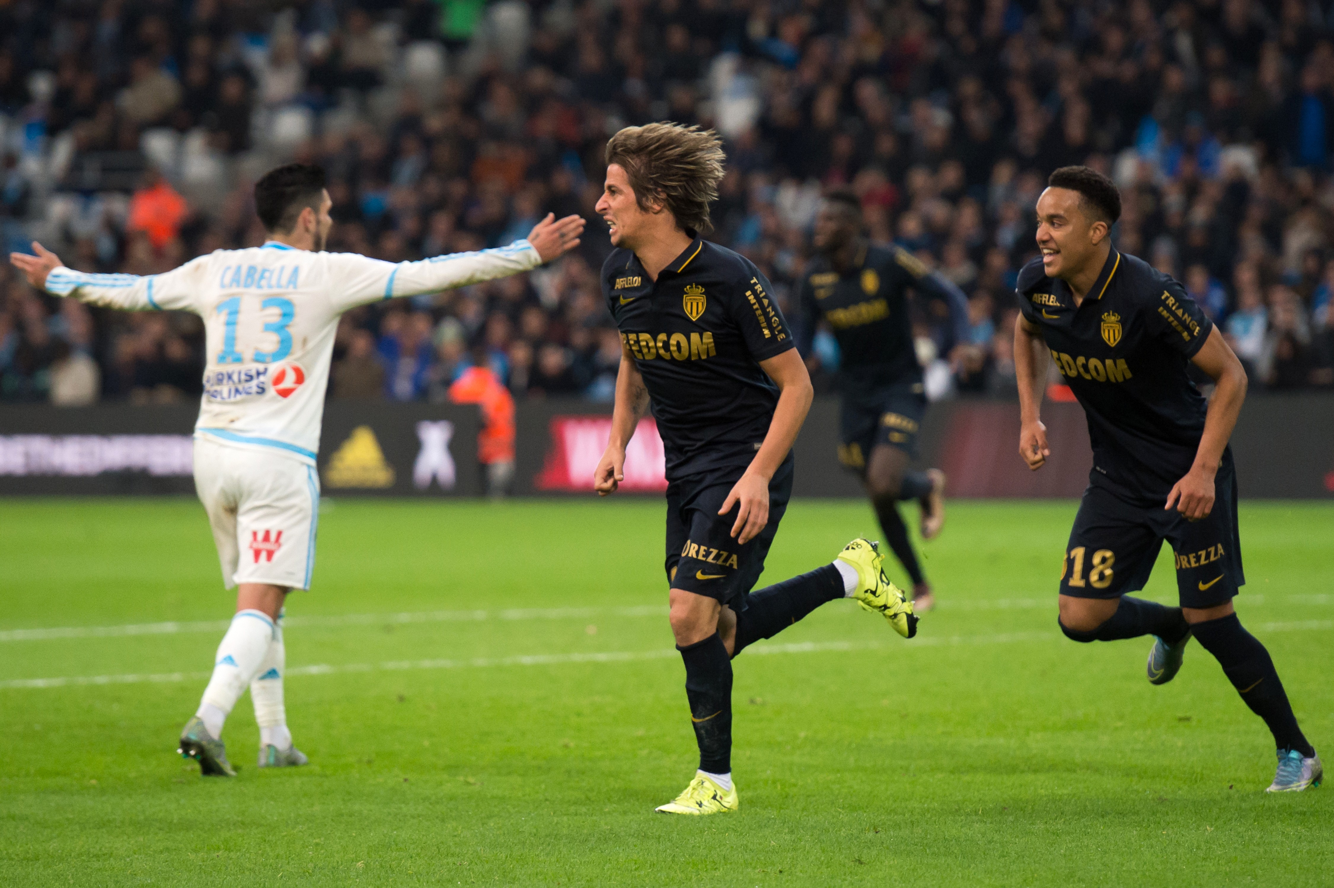 Monaco's Portuguese defender Fabio Coentrao (C) celebrates after scoring a goal during the French L1 football match Olympique de Marseille vs AS Monaco on November 29, 2015 at the Velodrome stadium in Marseille, southern France. AFP PHOTO / BERTRAND LANGLOIS / AFP / BERTRAND LANGLOIS        (Photo credit should read BERTRAND LANGLOIS/AFP/Getty Images)