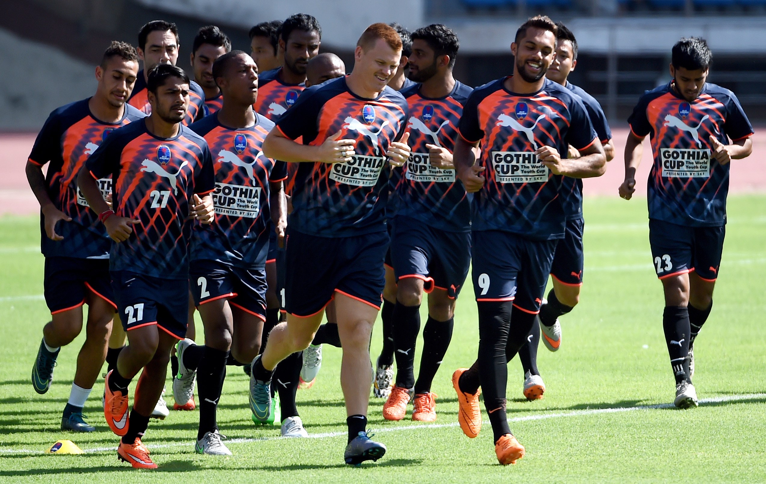 TO GO WITH FBL-IND-INDIA-ISL, FOCUS BY PETER HUTCHINSON

In this photograph taken on September 30, 2015, Delhi Dynamos FC players jog as they warm up in a training session at the Jawaharlal Nehru Stadium in New Delhi.   India's glitzy super league returns this weekend, but a struggling national team and insufficient facilities in the cricket-mad country means the "sleeping giant" of world football is unlikely to stir anytime soon.   AFP PHOTO / MONEY SHARMA        (Photo credit should read MONEY SHARMA/AFP/Getty Images)